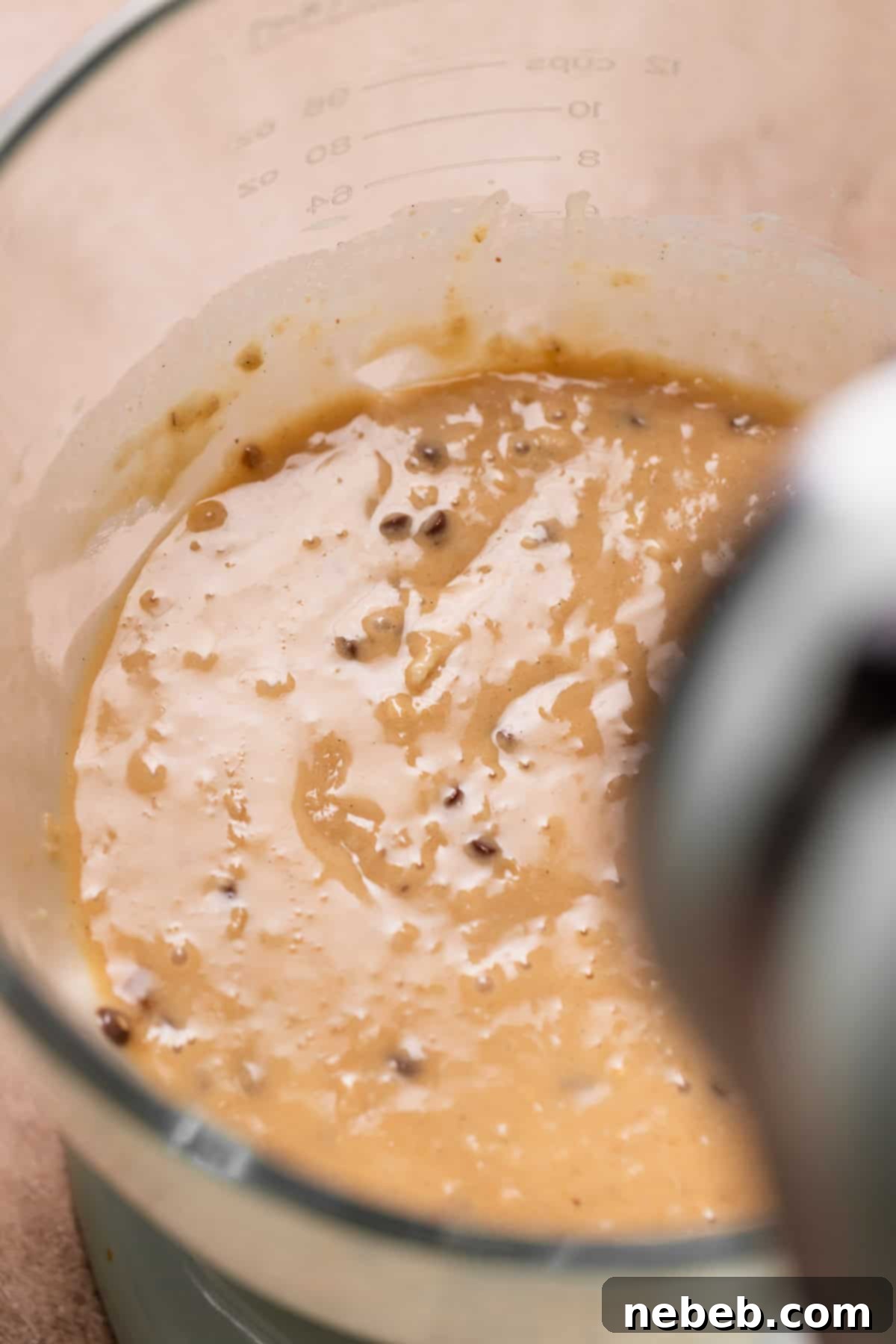 Oatmeal peanut butter cupcake batter in a mixing bowl, showing a thick and creamy consistency.