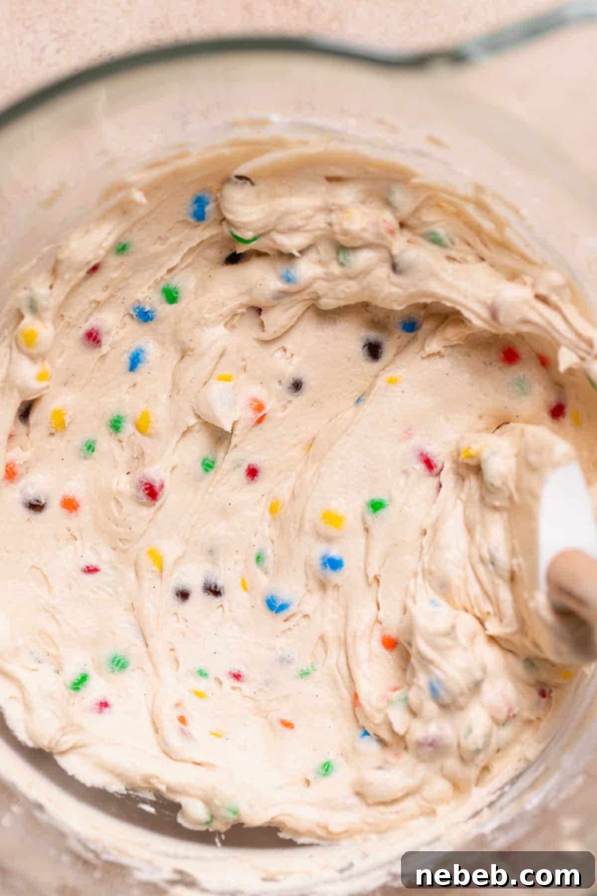 A mixing bowl with the M&M buttercream frosting, showing a creamy, thick consistency.