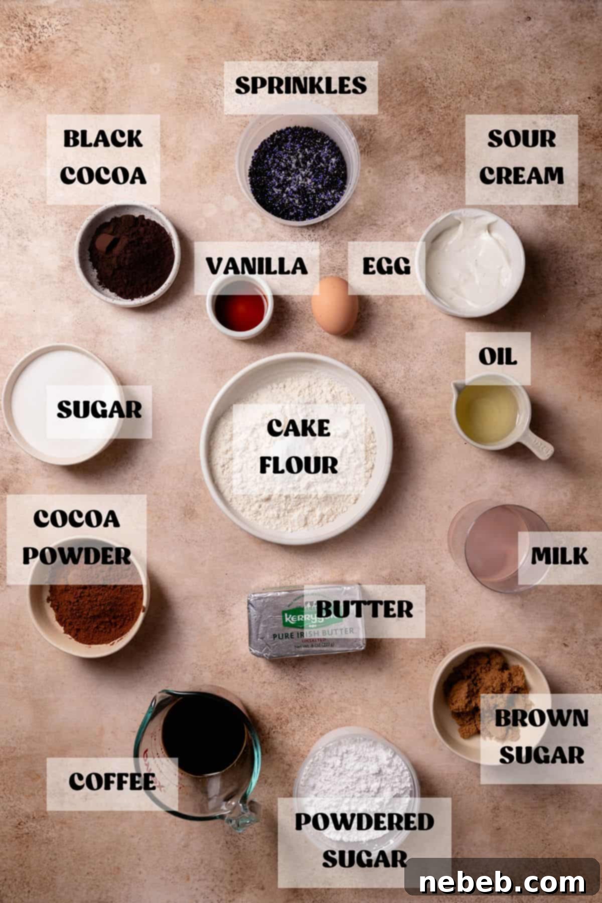 Ingredients needed to make black cocoa cupcakes laid out in bowls with labels.