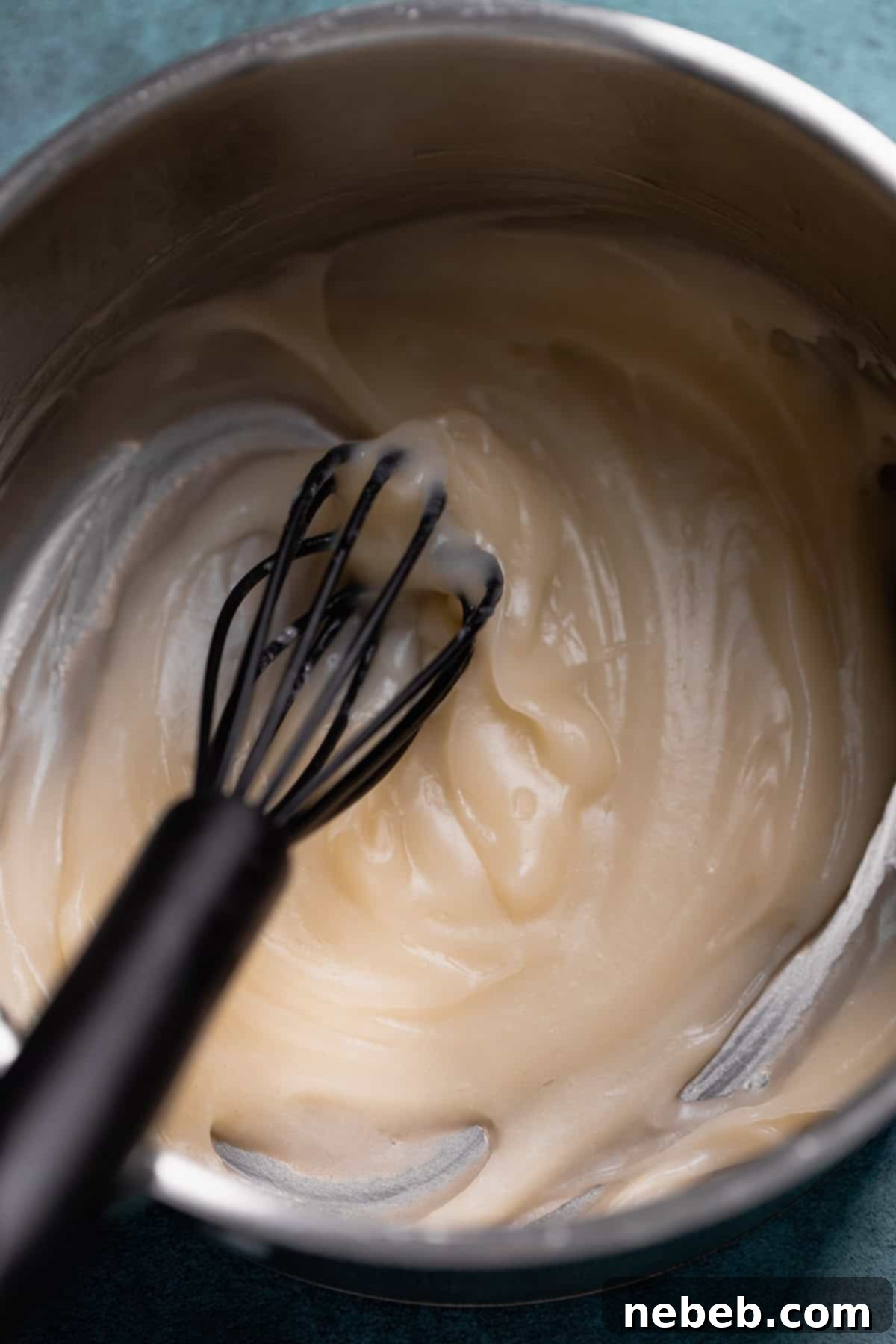 Tangzhong in a pot being whisked to form a paste.