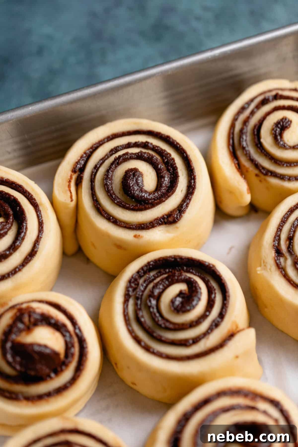A pan of chocolate rolls after doubling in size, ready for baking.