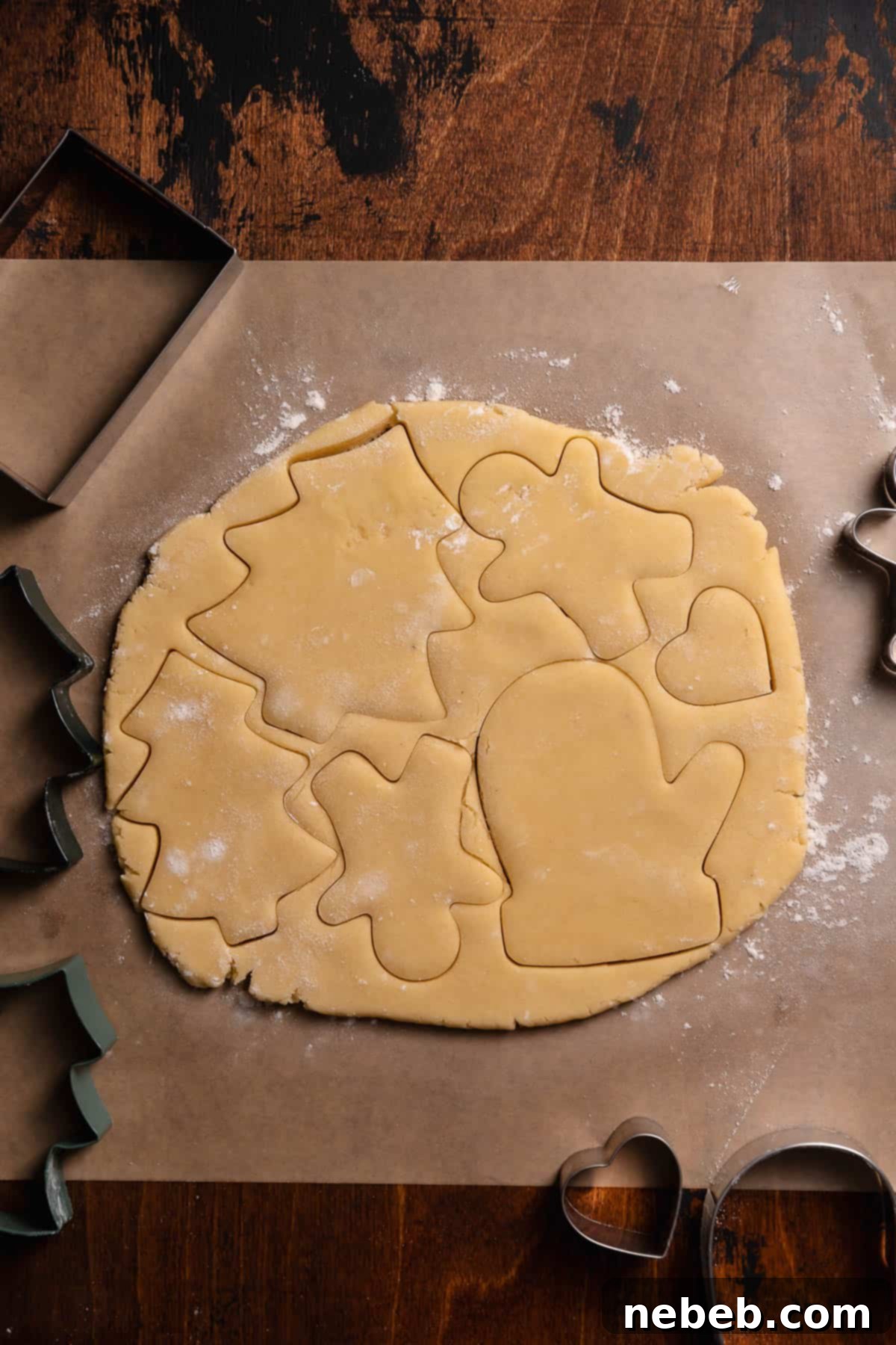 Perfect Bakery-Style Cut-Out Sugar Cookies 8 A slab of rolled out cookie dough with cookie cutter imprints.