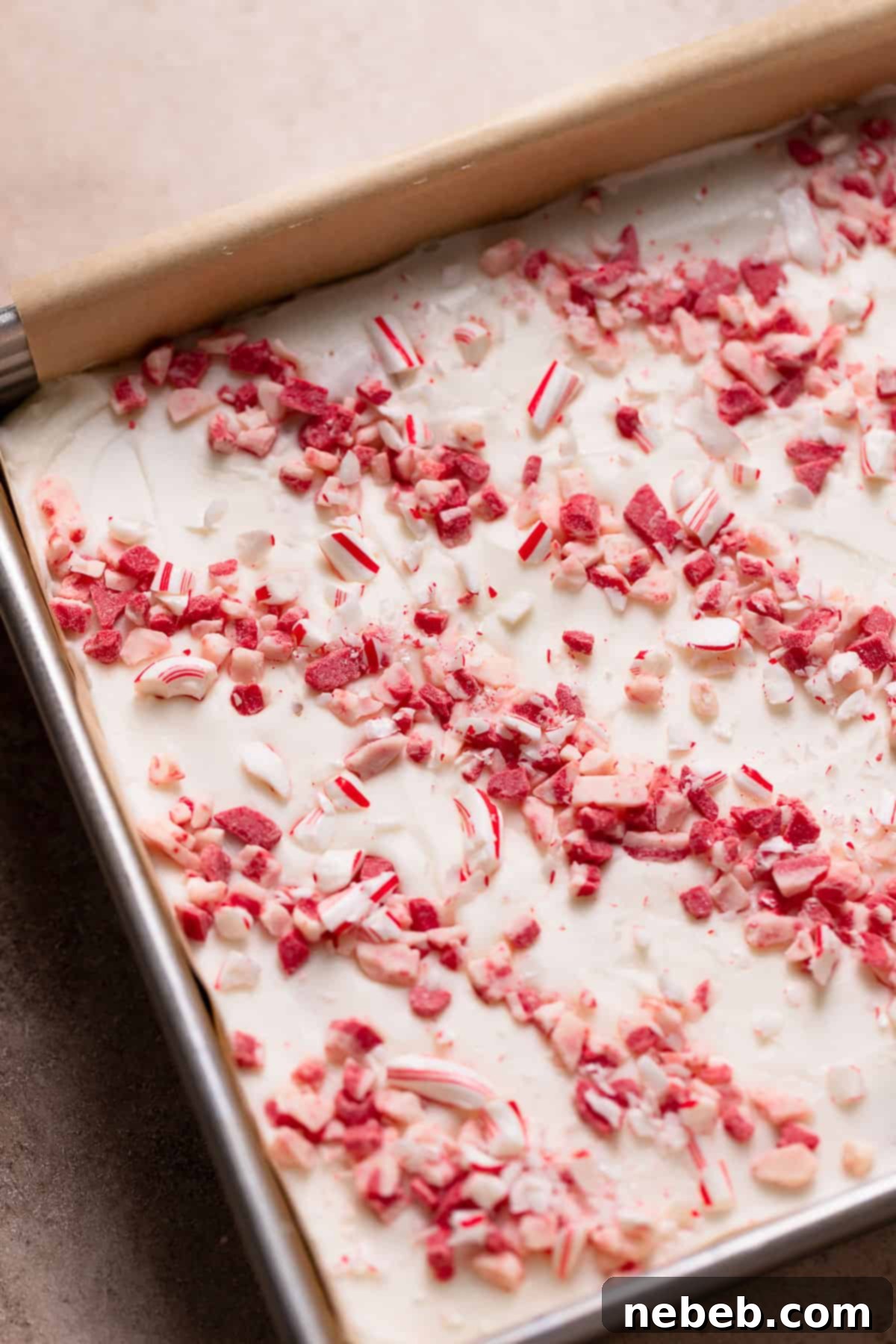 Cool Mint Chocolate Brownies 9 Finished peppermint brownies in a pan, topped with a smooth layer of white peppermint frosting, sprinkled with peppermint chips and crushed candy canes.