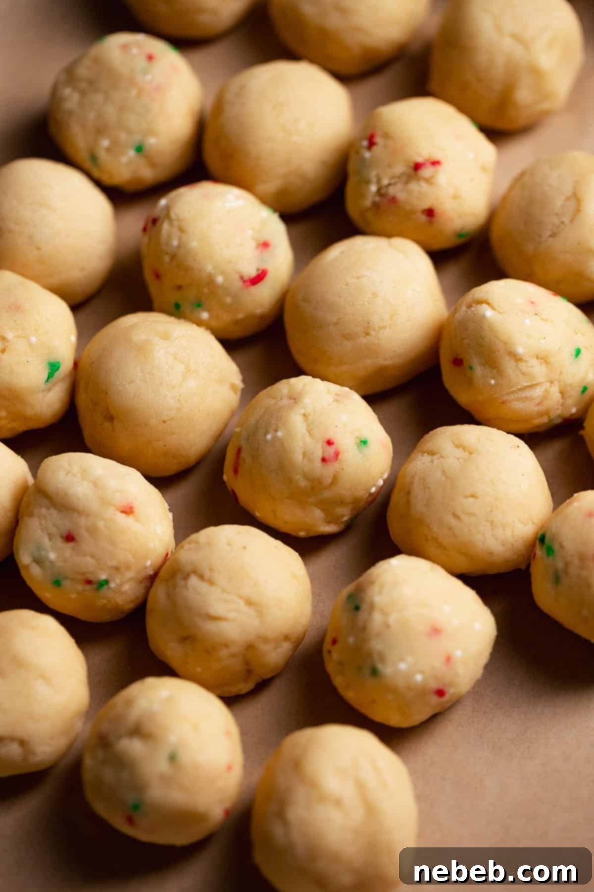 Rolled sugar cookie balls on a tray.