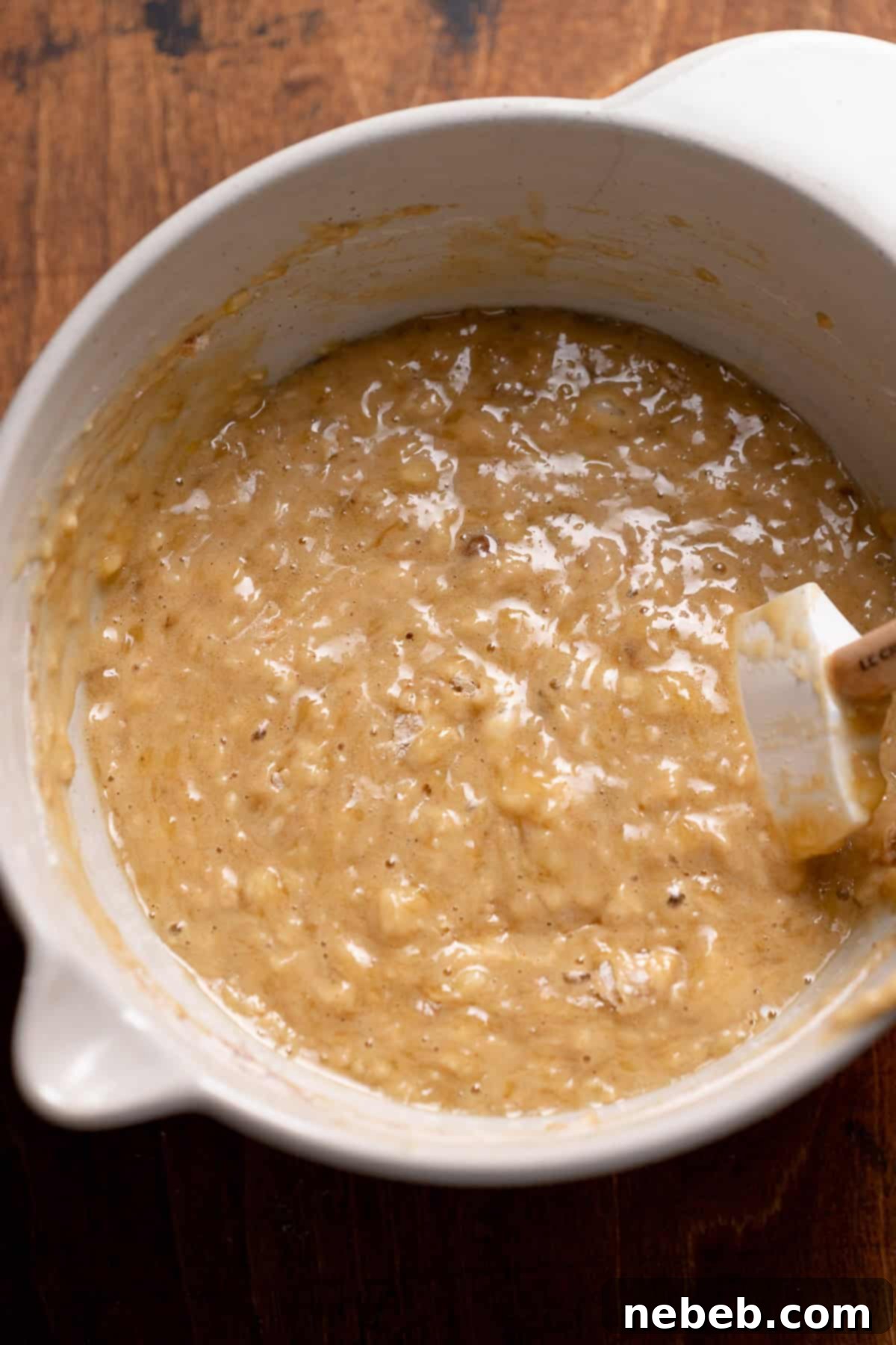 A bowl full of rich, thick banana bread batter, ready for baking.