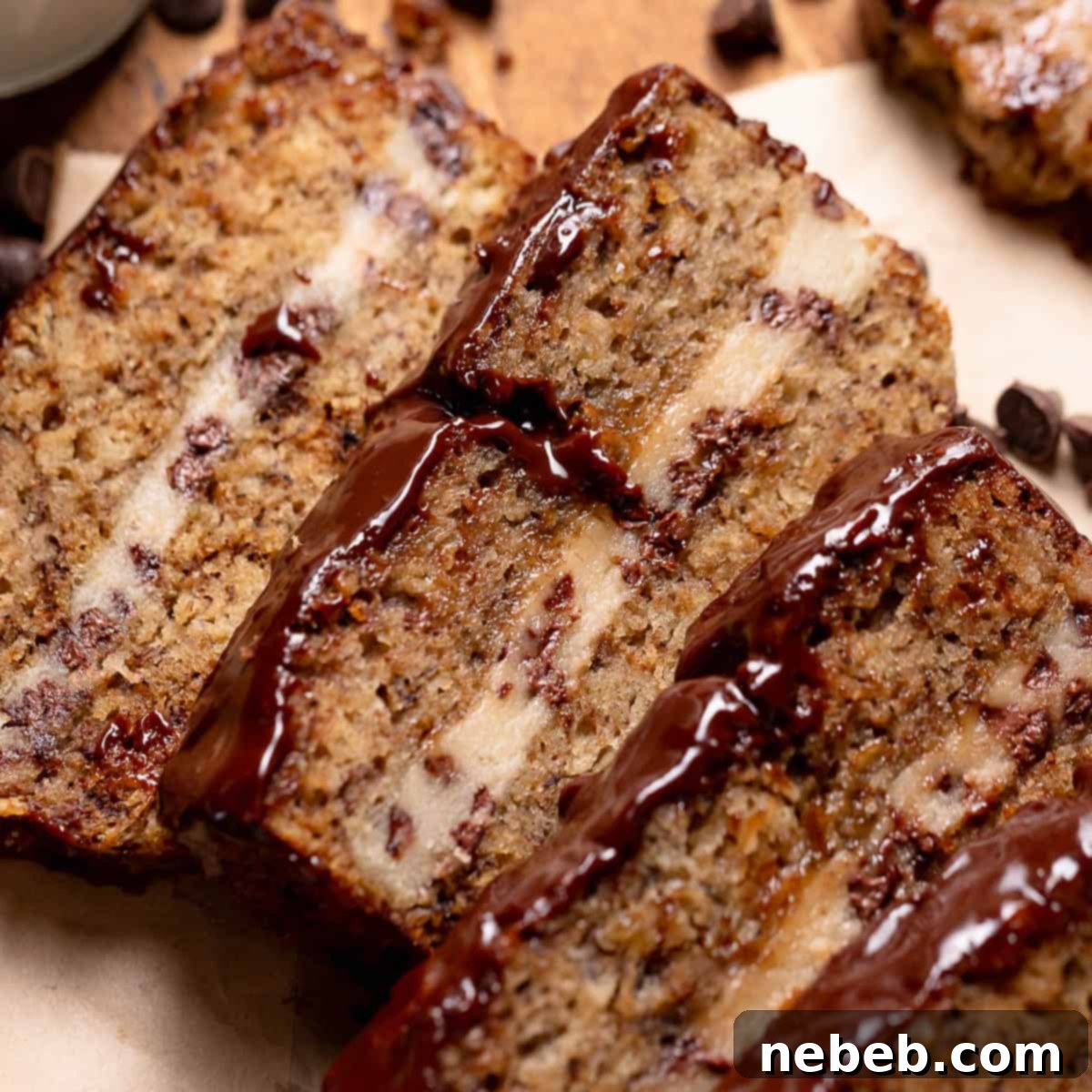 Slices of banana bread on parchment paper, displaying the baked cookie dough center.