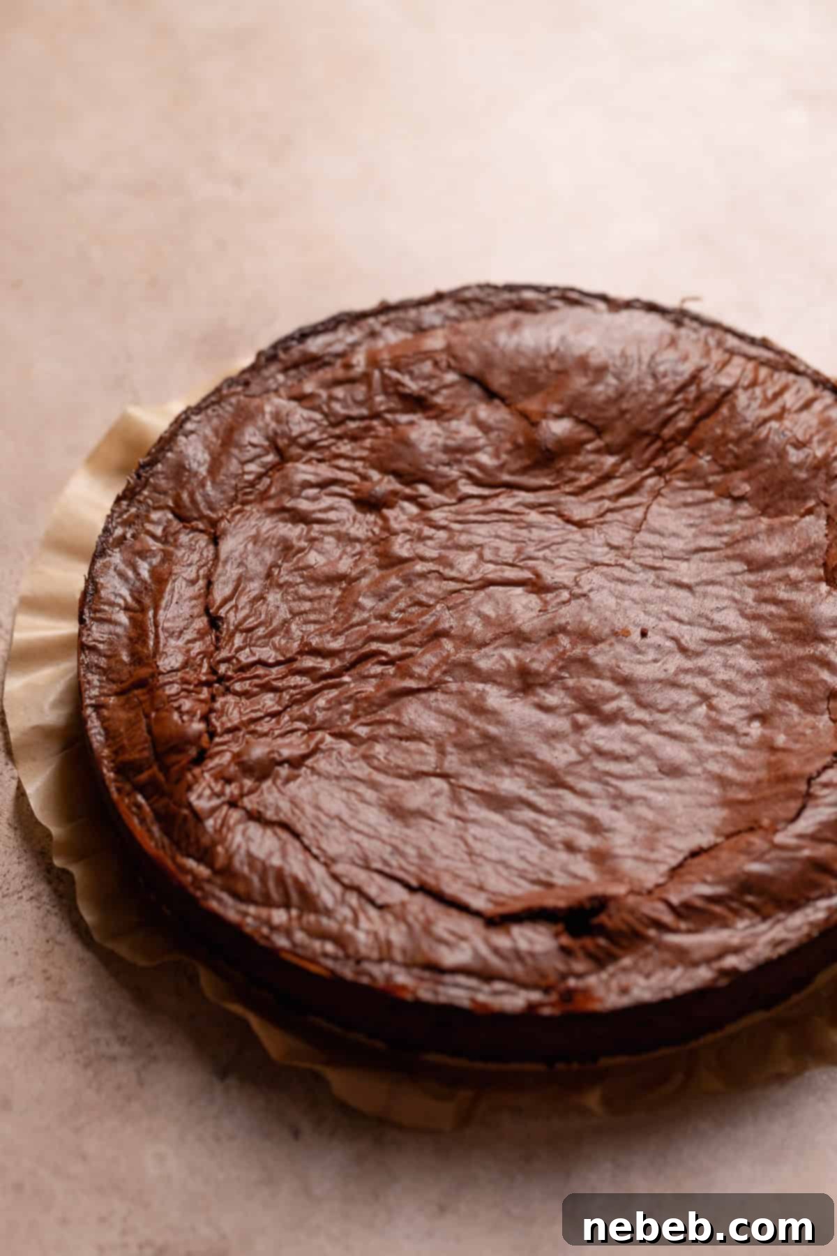 The brownie cake after baking on parchment paper.