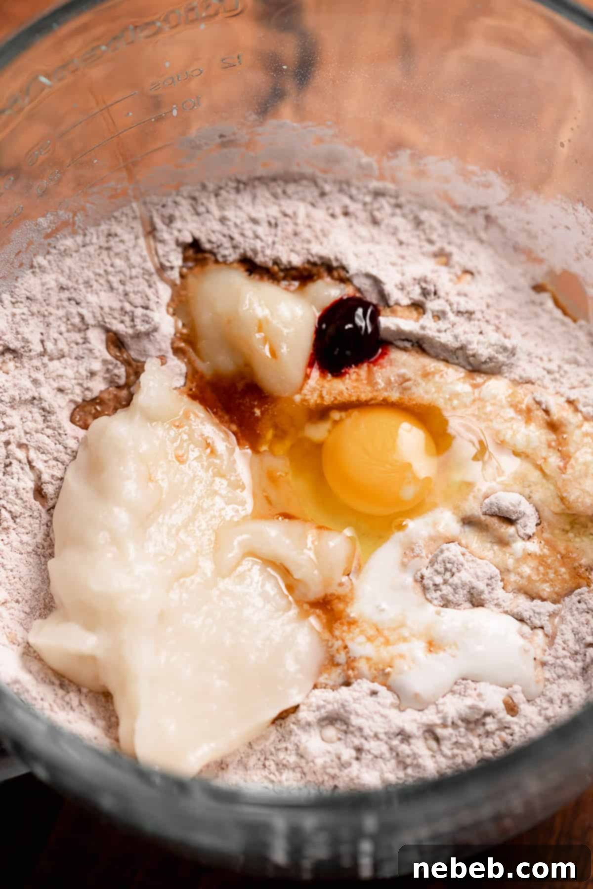 Wet and dry cinnamon roll ingredients in a mixing bowl before mixing.