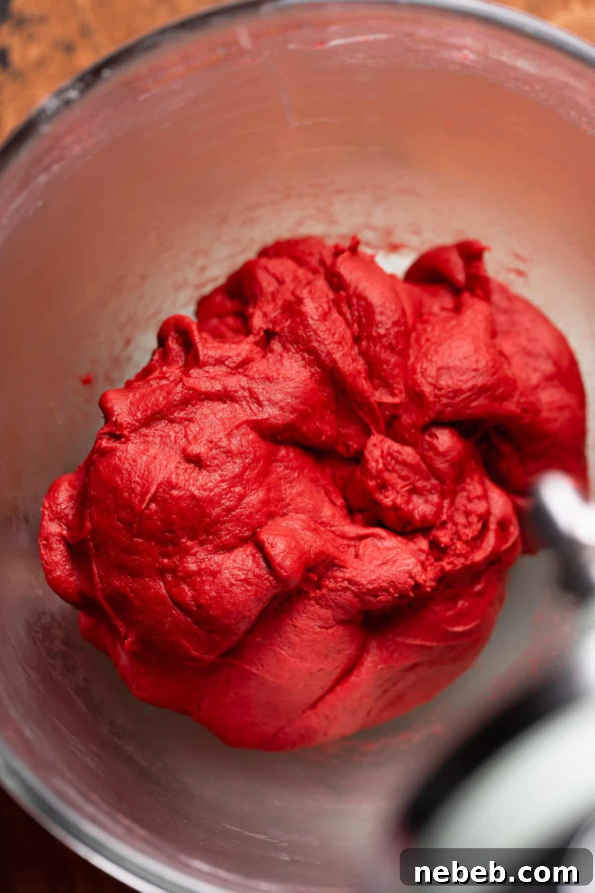Red velvet dough in a mixing bowl.