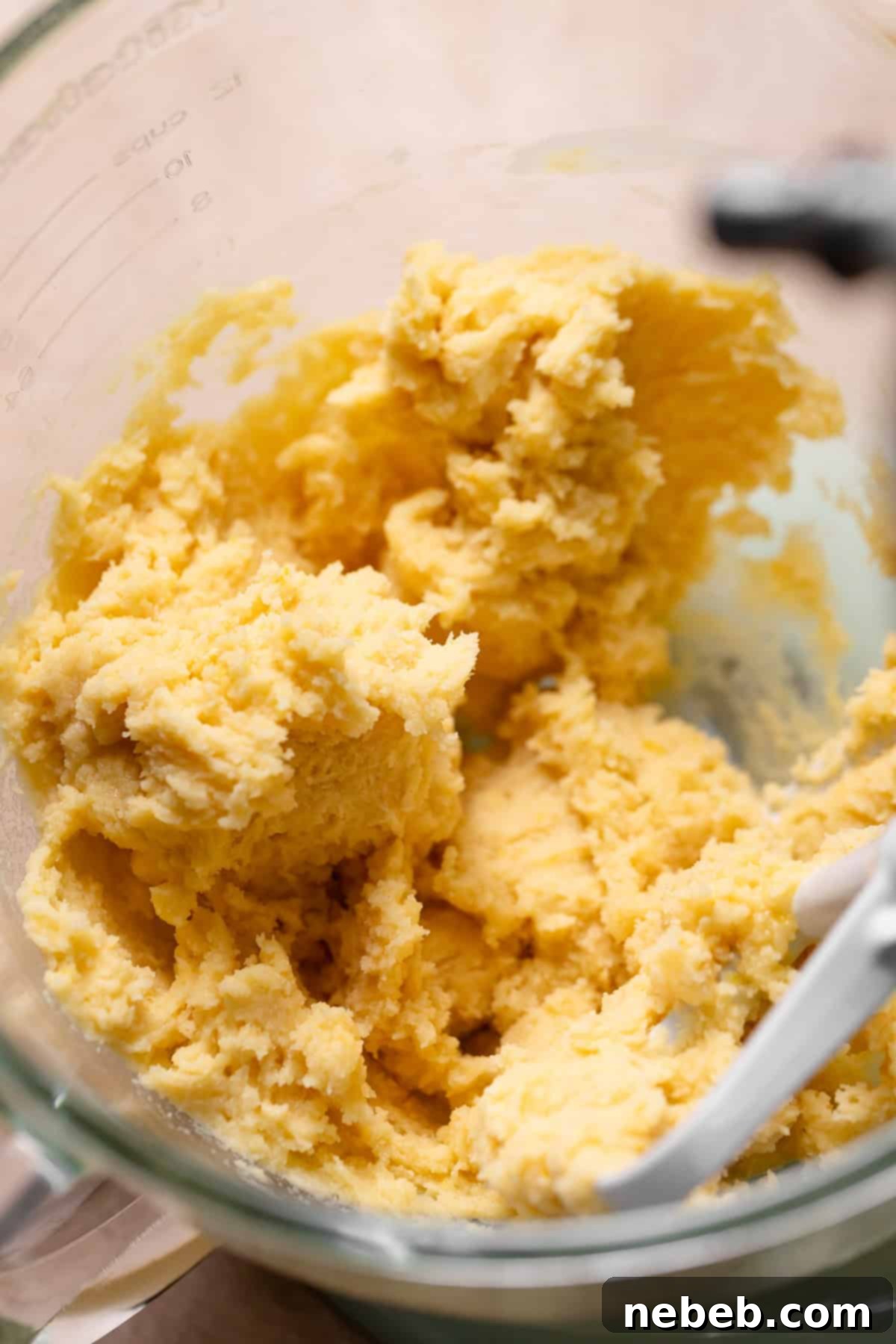 A mixing bowl with the pasty cake batter in it.