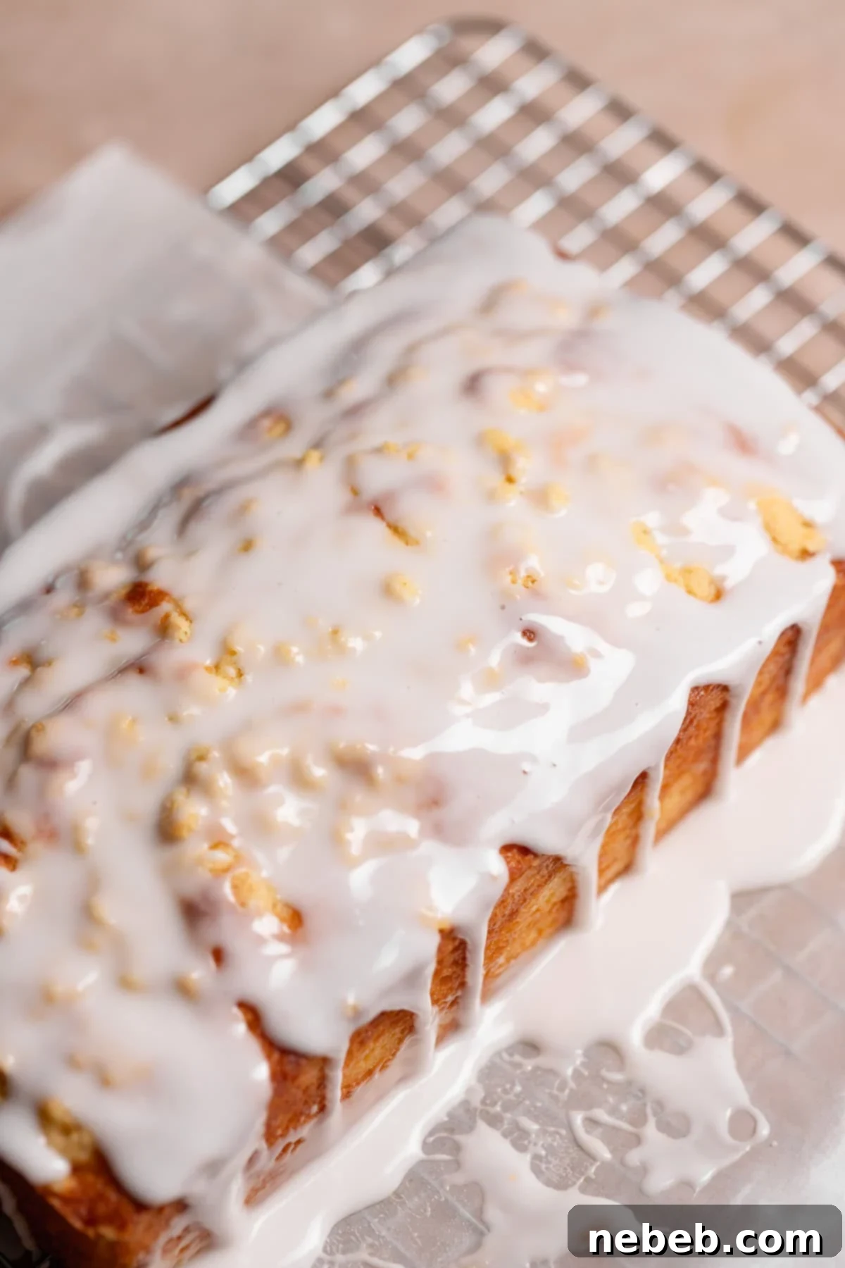 The iced lemon loaf on parchment paper before cutting.