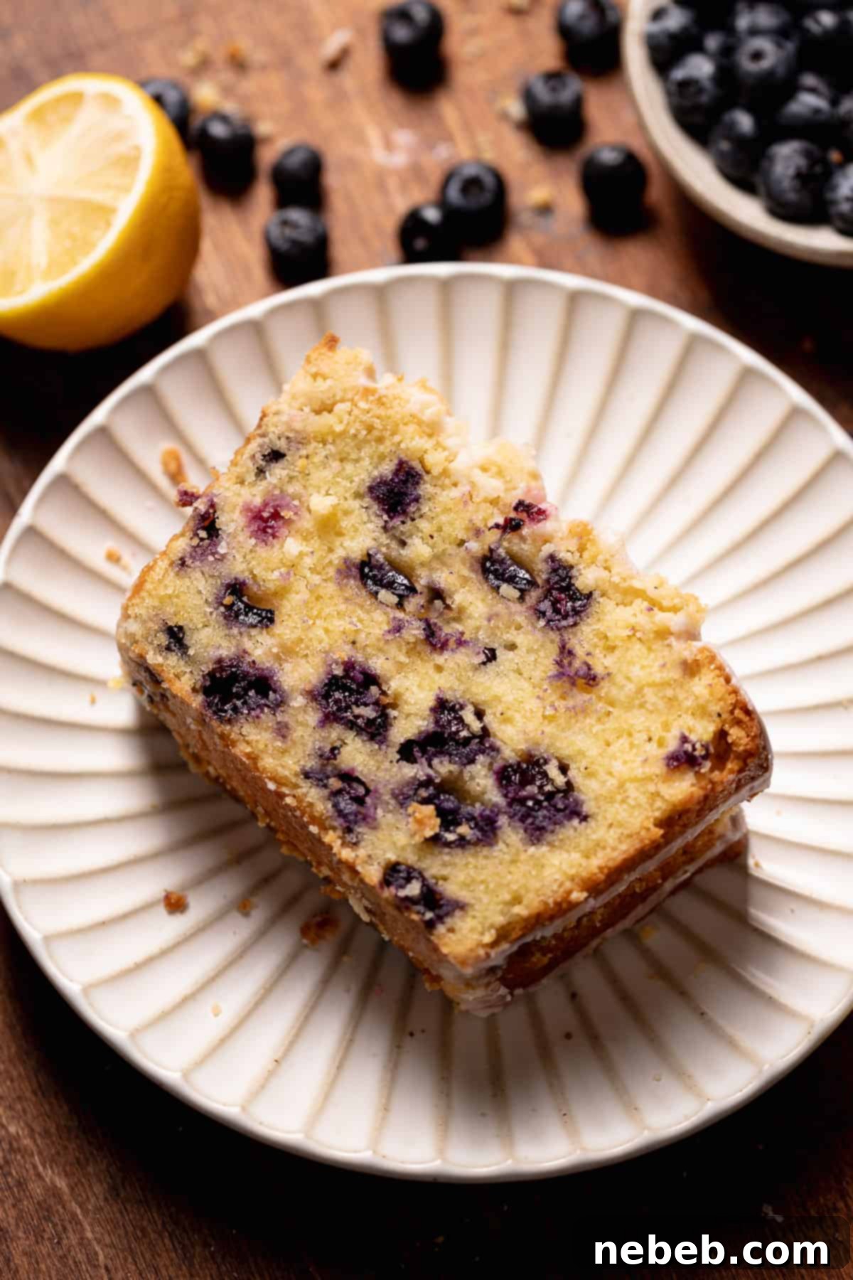A slice of lemon blueberry cake on a plate.