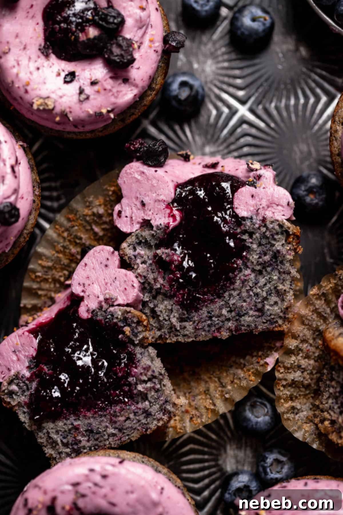 Blueberry filled cupcake cut in half to show the blueberry jam centers.