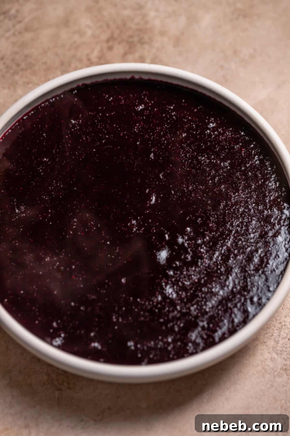 Blueberry jam filling in a white dish.