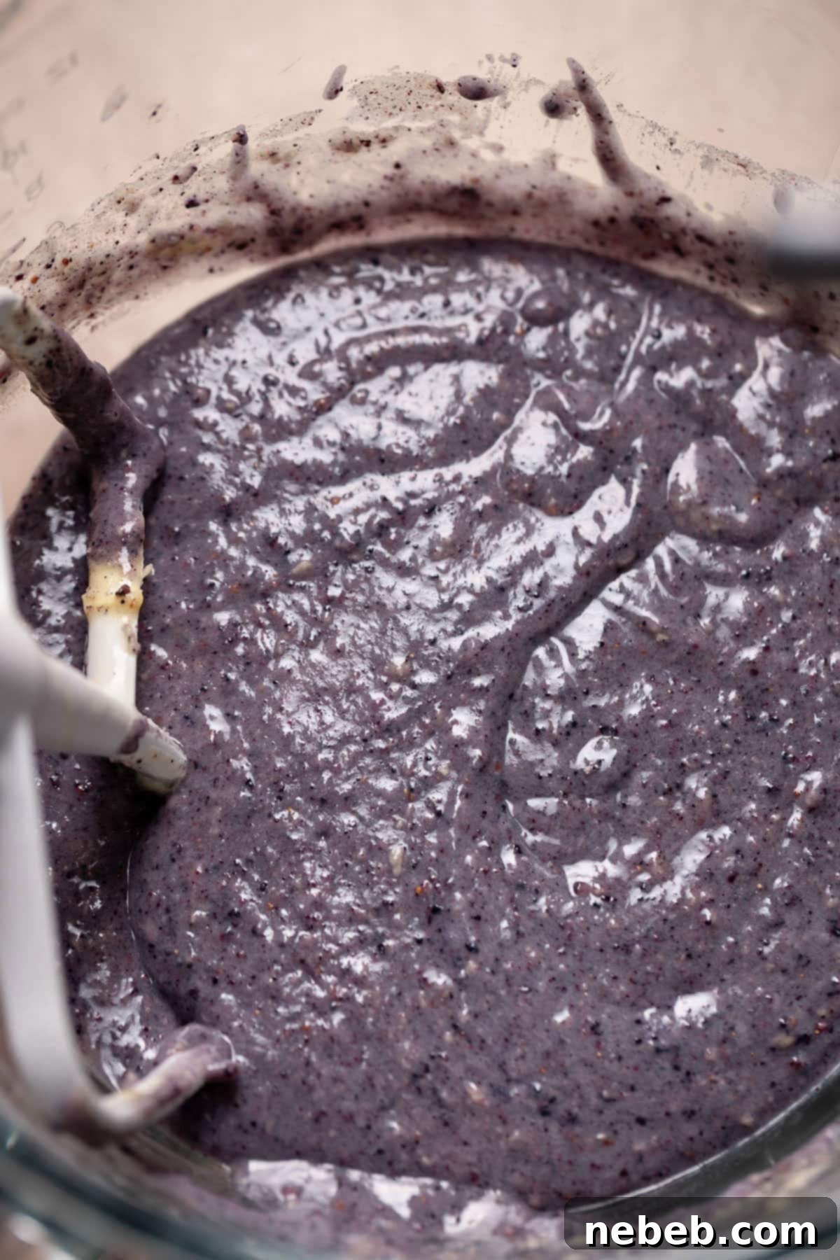 Purple blueberry cupcake batter in a mixing bowl.