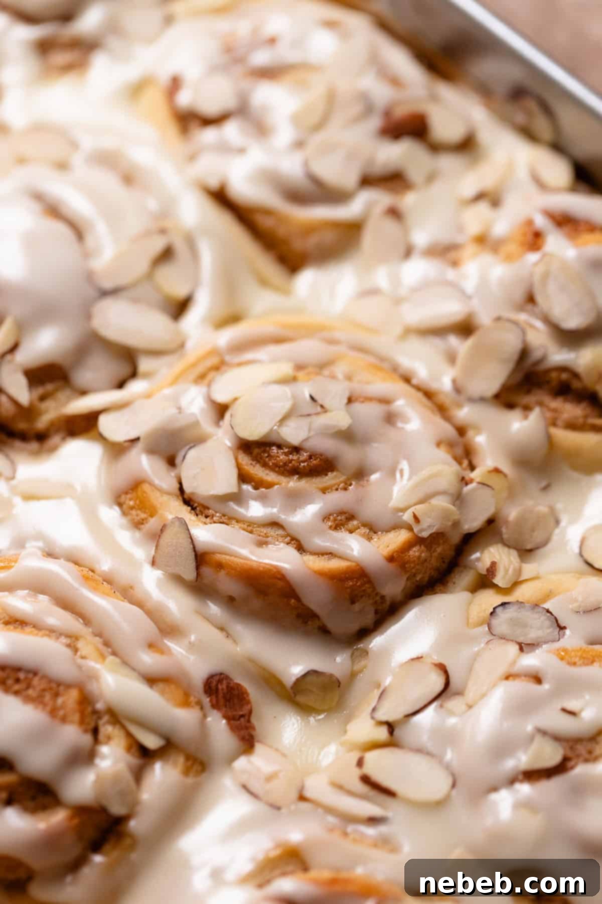 Almond croissant rolls with almond glaze and sliced almonds on top.
