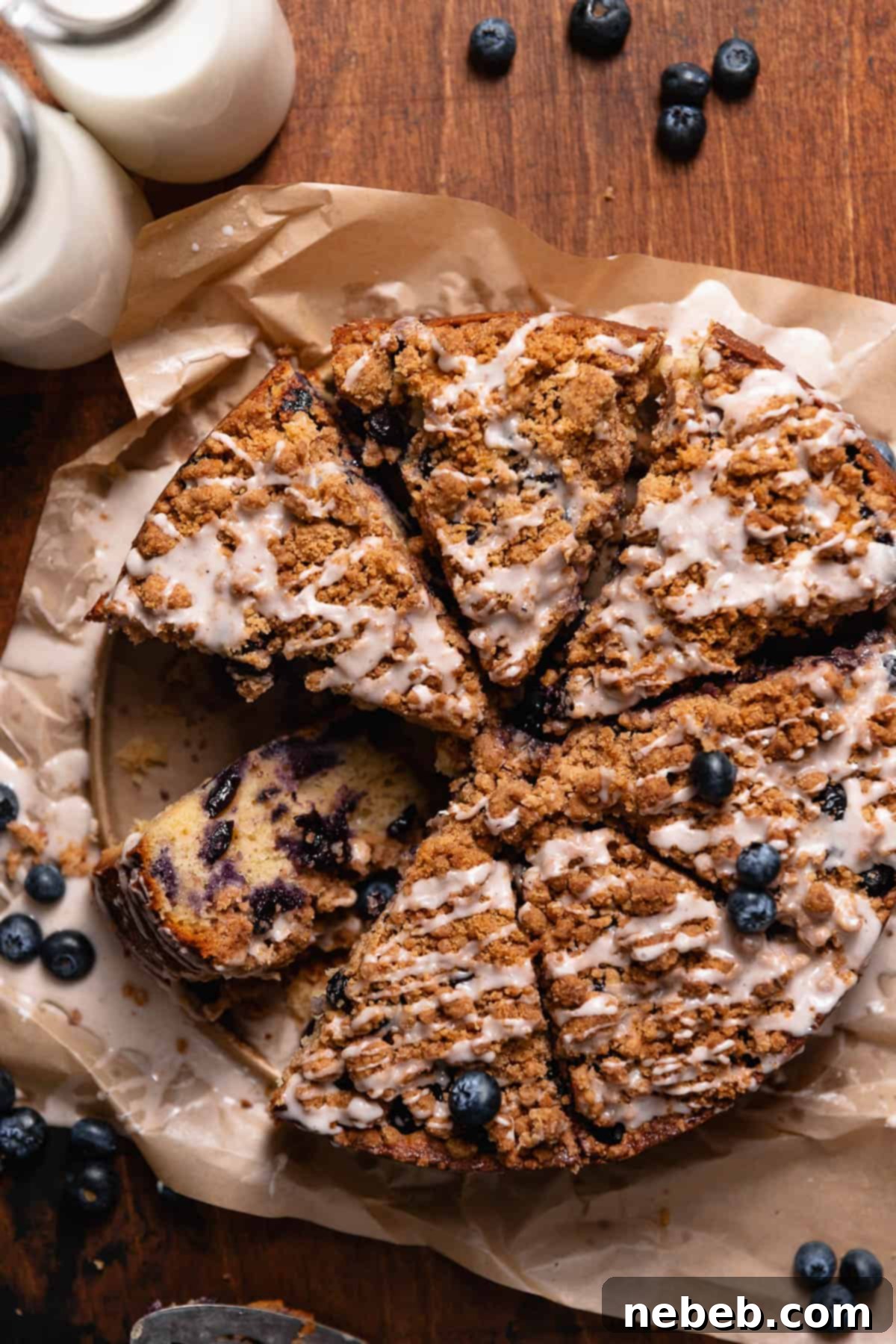 Luscious Blueberry Sour Cream Coffee Cake 2 Blueberry coffee cake slices on a wooden backdrop.