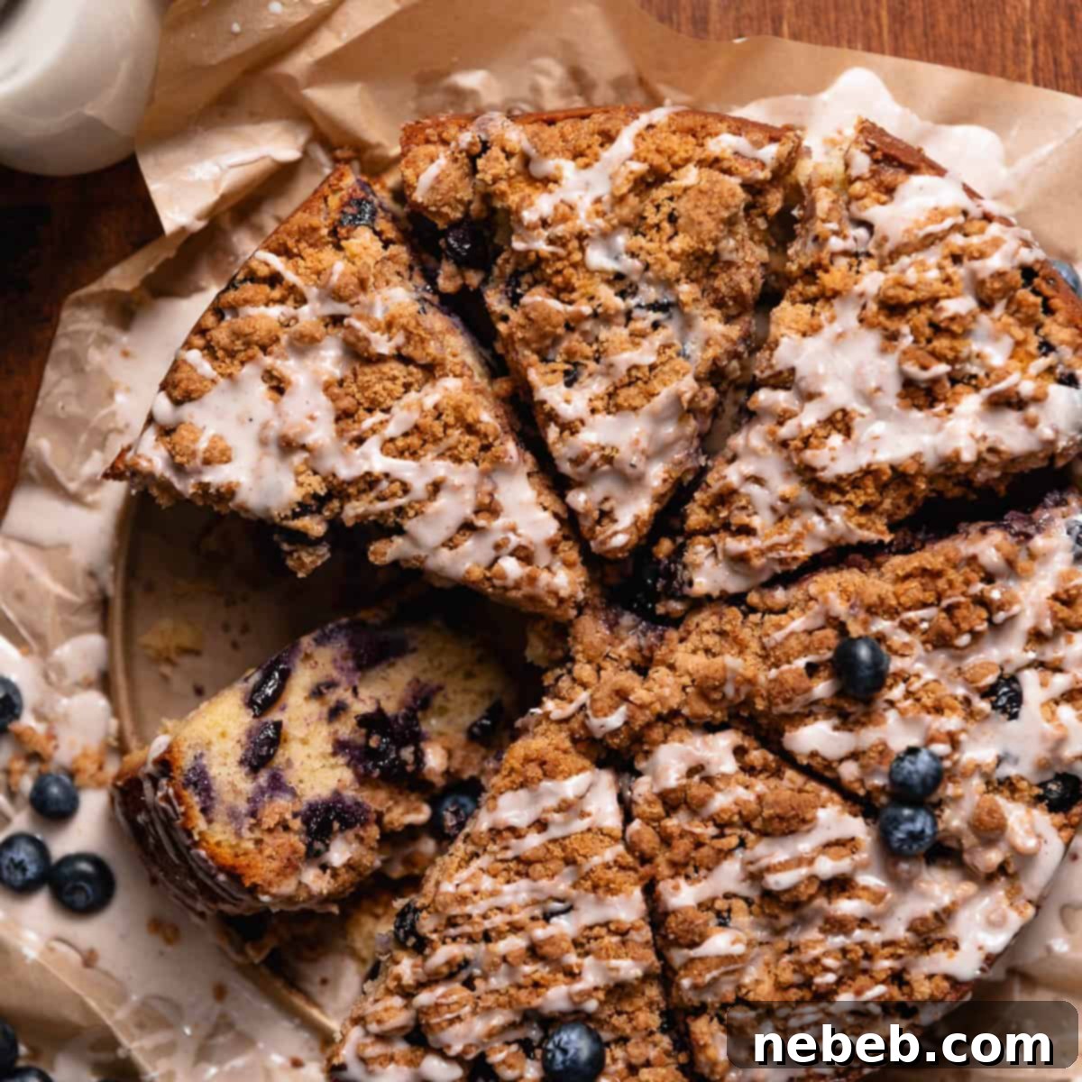 Luscious Blueberry Sour Cream Coffee Cake 12 Slices of blueberry streusel coffee cake on brown parchment paper.