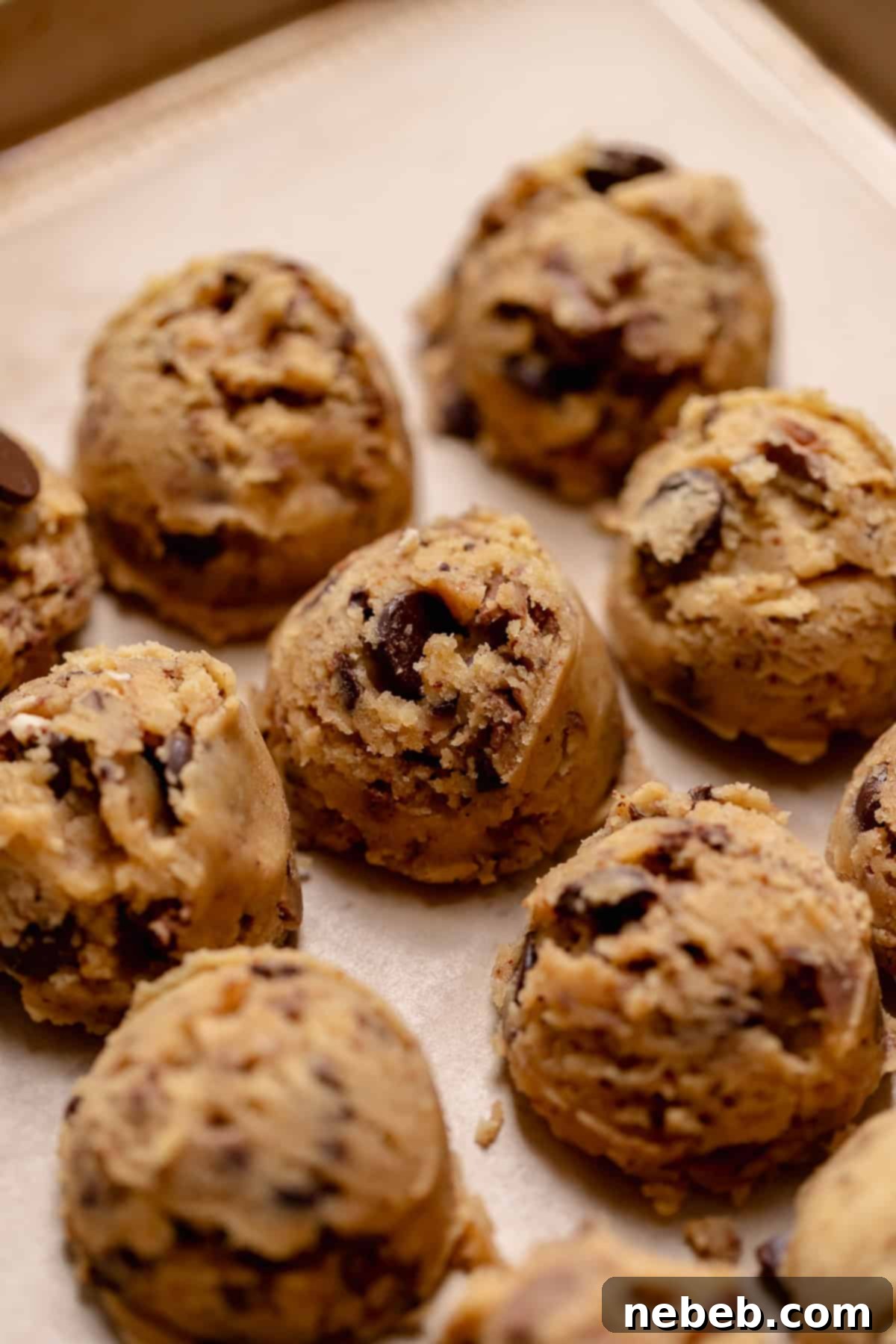 Brown butter chocolate chip cookie dough balls on a baking tray.