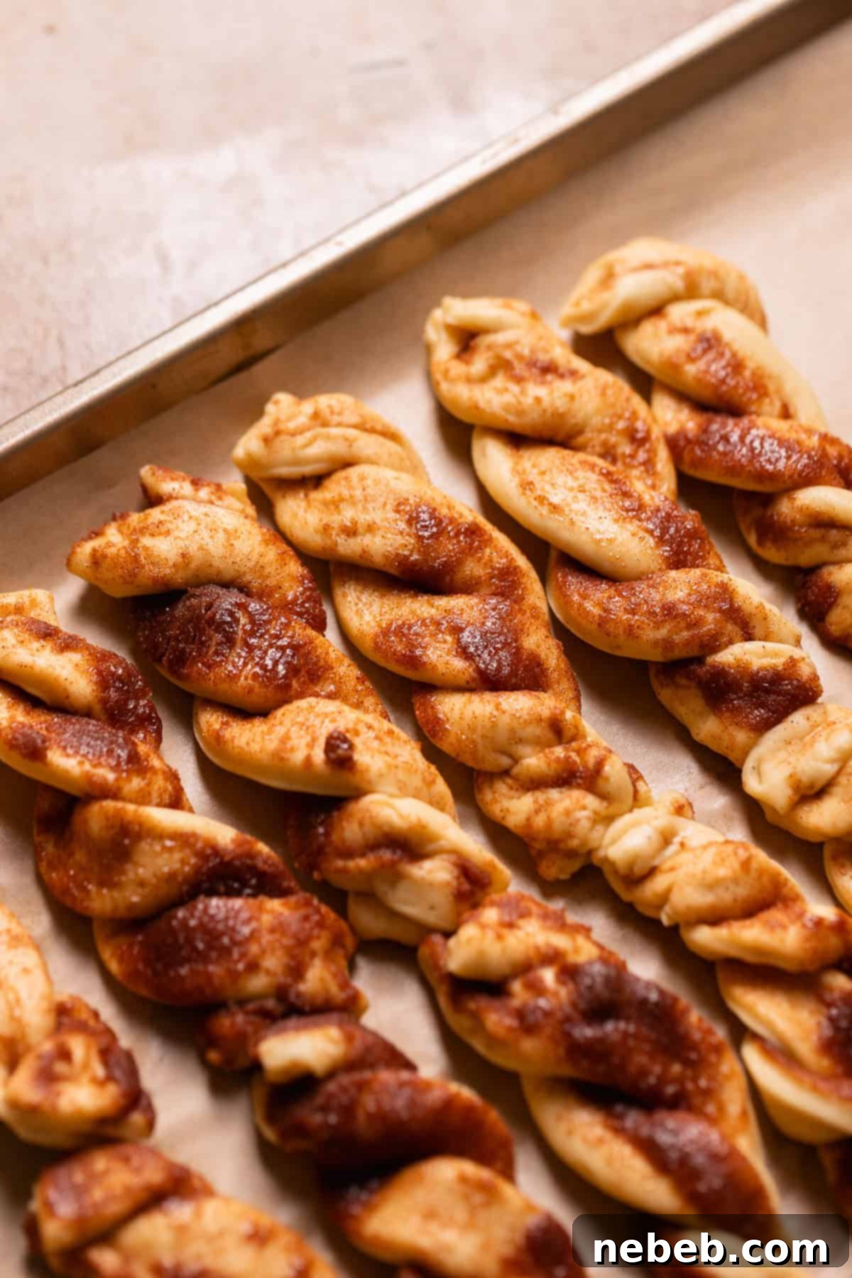 Cinnamon sugar twists on a baking sheet.