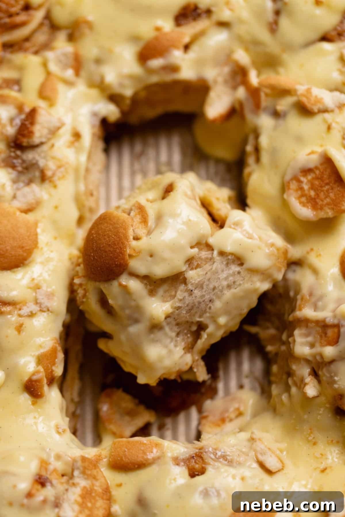 Decadent Banana Pudding Cinnamon Rolls 2 Banana pudding rolls in a baking pan, golden brown and ready to be frosted.