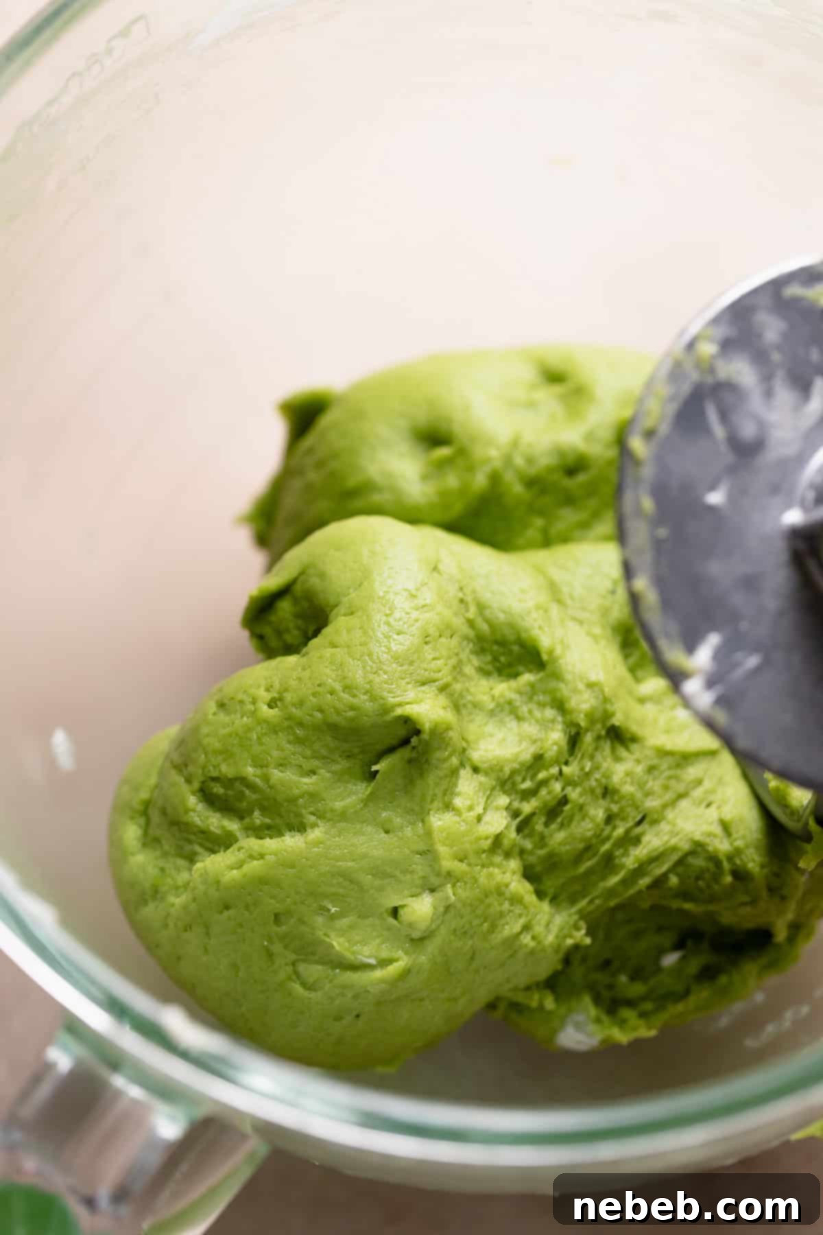 Smooth, elastic matcha dough resting in a mixing bowl after kneading.