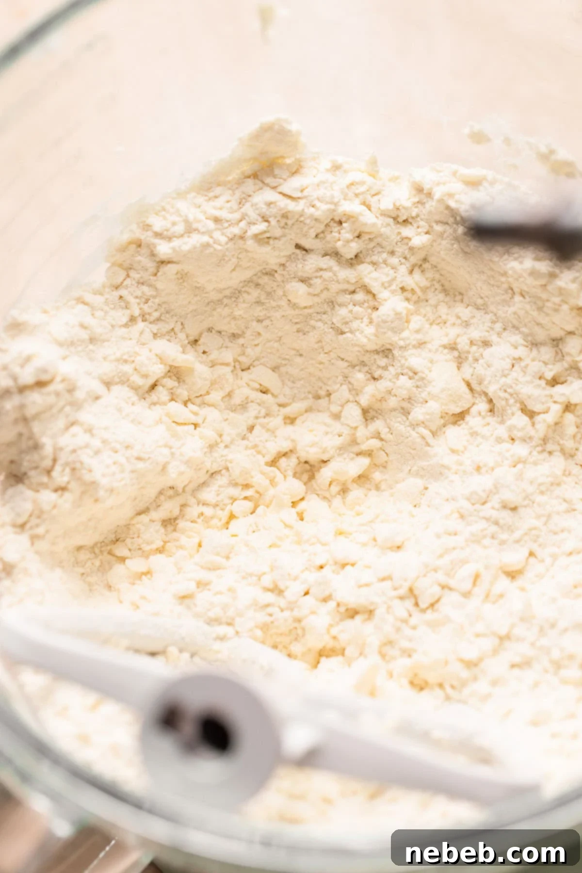 Flour and butter mixed to pea sized bits in a mixer bowl for the pie dough.