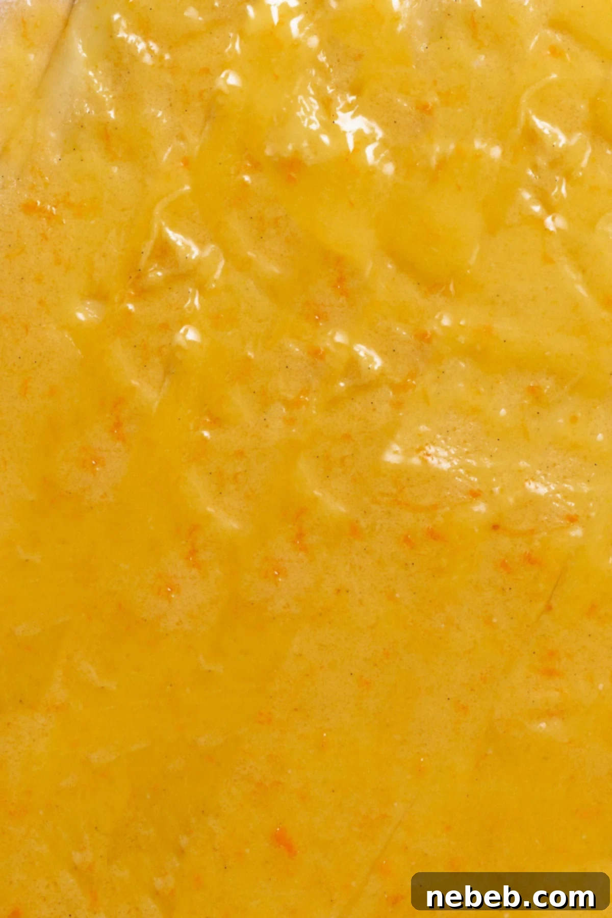 Orange curd and sugar filling spread onto the cinnamon roll dough.