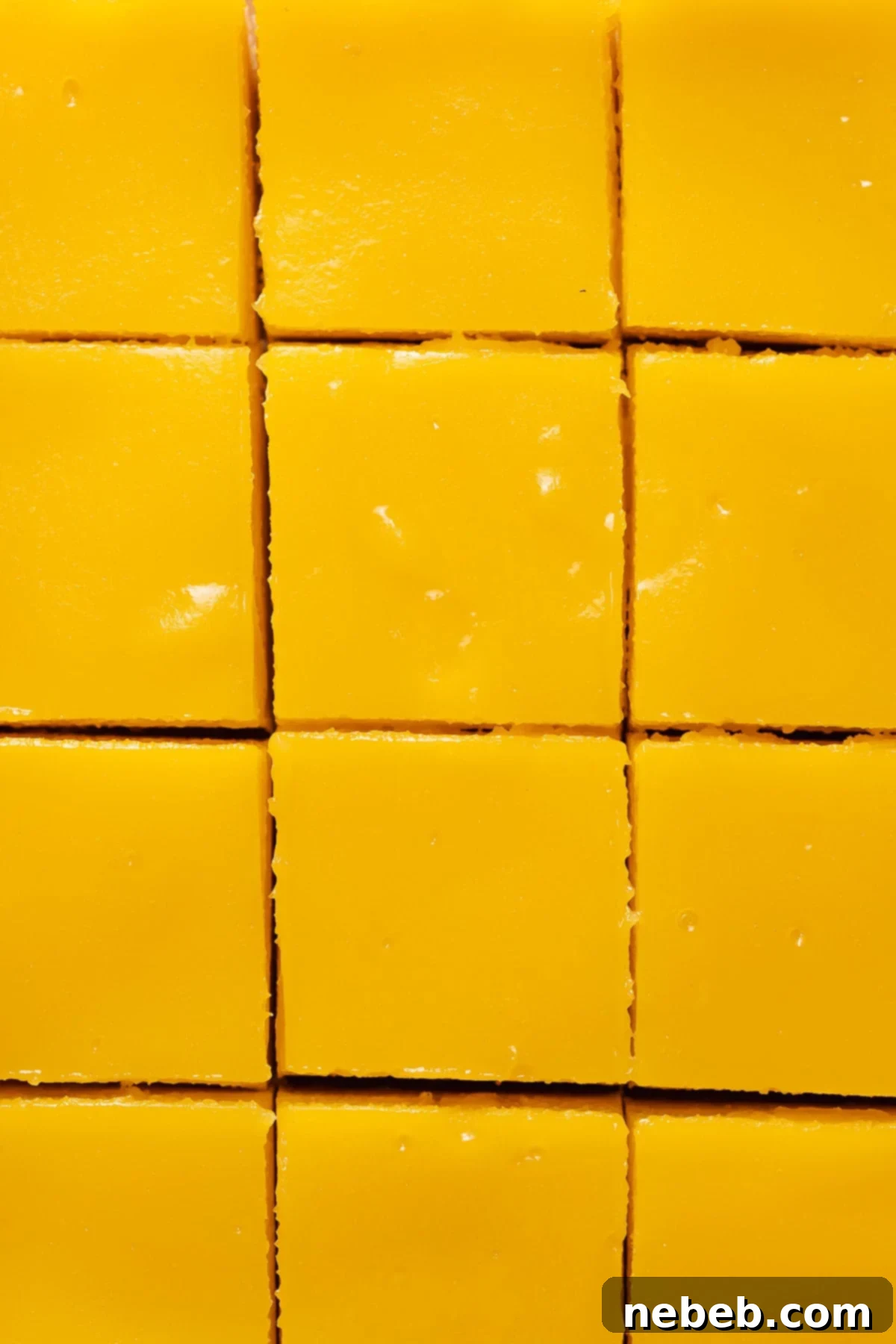 Freshly baked lemon bars, cooled and cut into perfect squares, ready for a final dusting of powdered sugar.