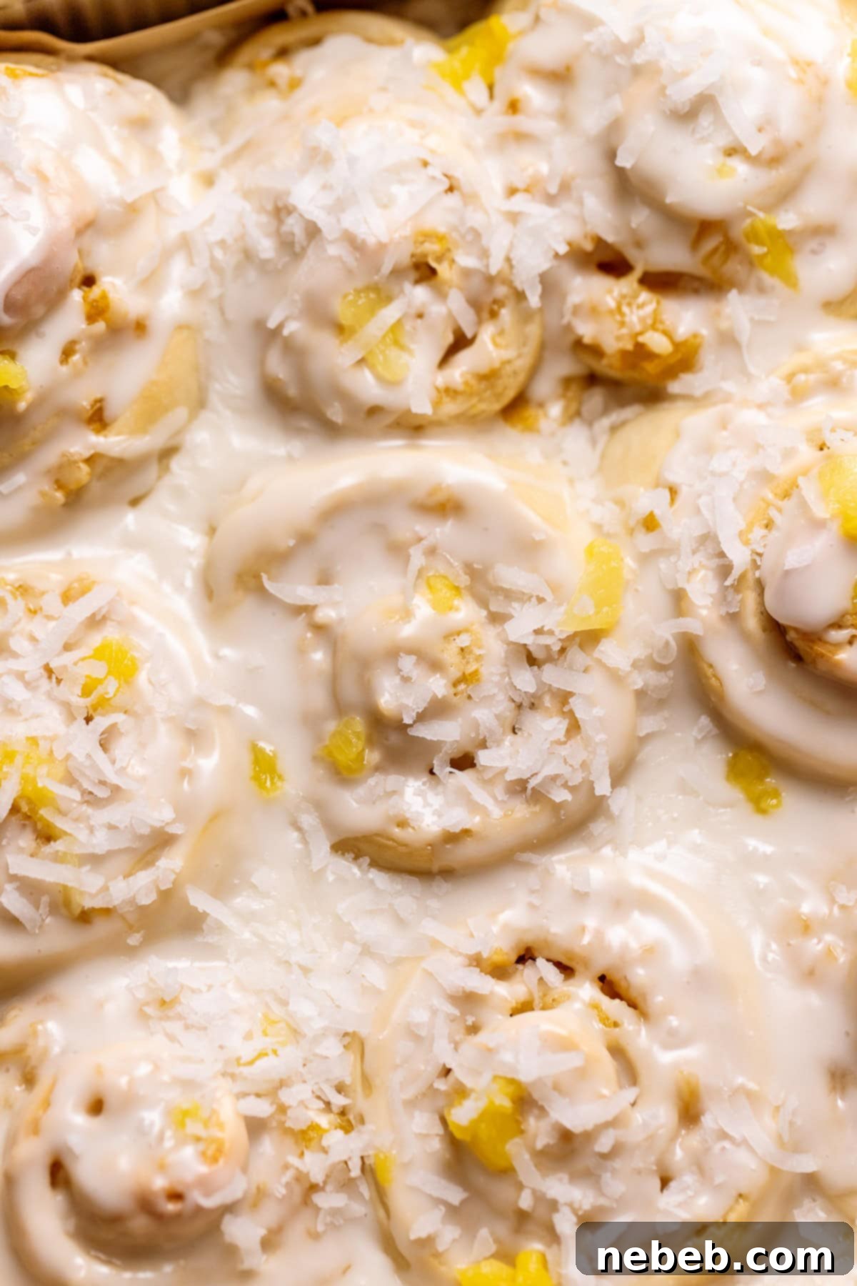 Pina colada cinnamon rolls topped with coconut and pineapple.