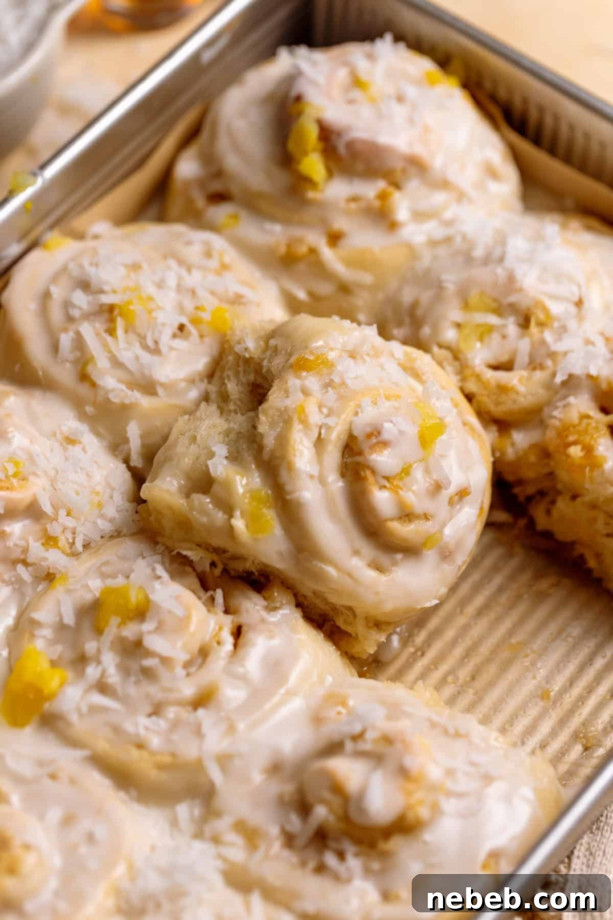 Pineapple coconut rolls in a baking pan.