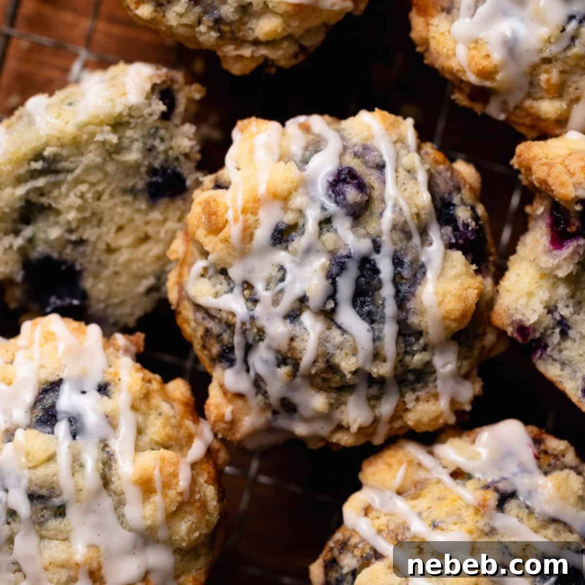An overhead shot of the crumb topped blueberry muffins drizzled with vanilla glaze.