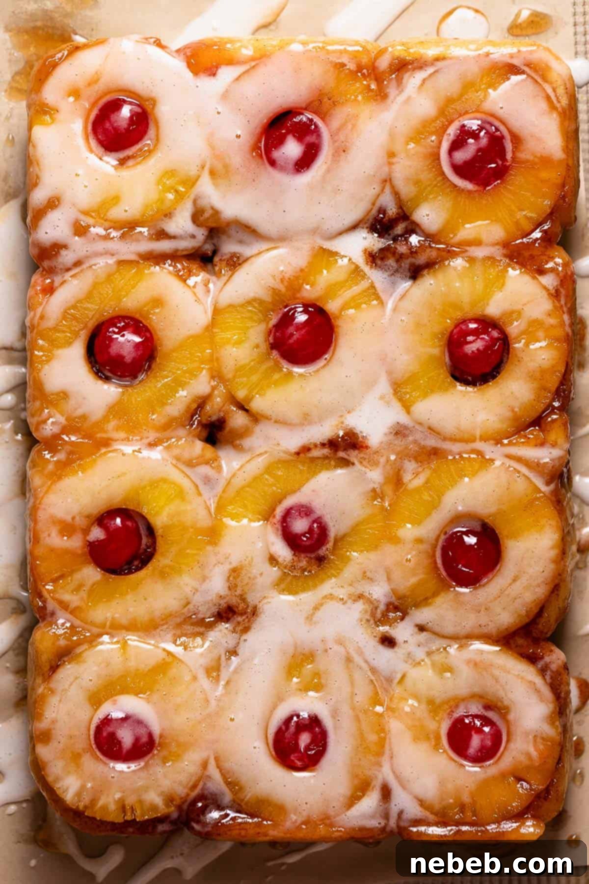 The flipped cinnamon rolls on a pan to show the caramelized pineapple tops.