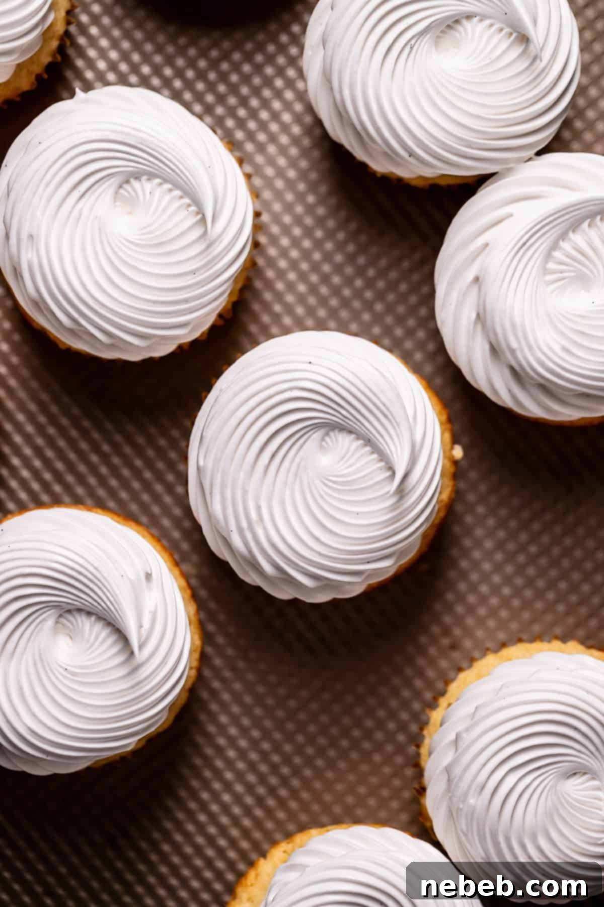 The tops of the cupcakes frosted with meringue frosting.