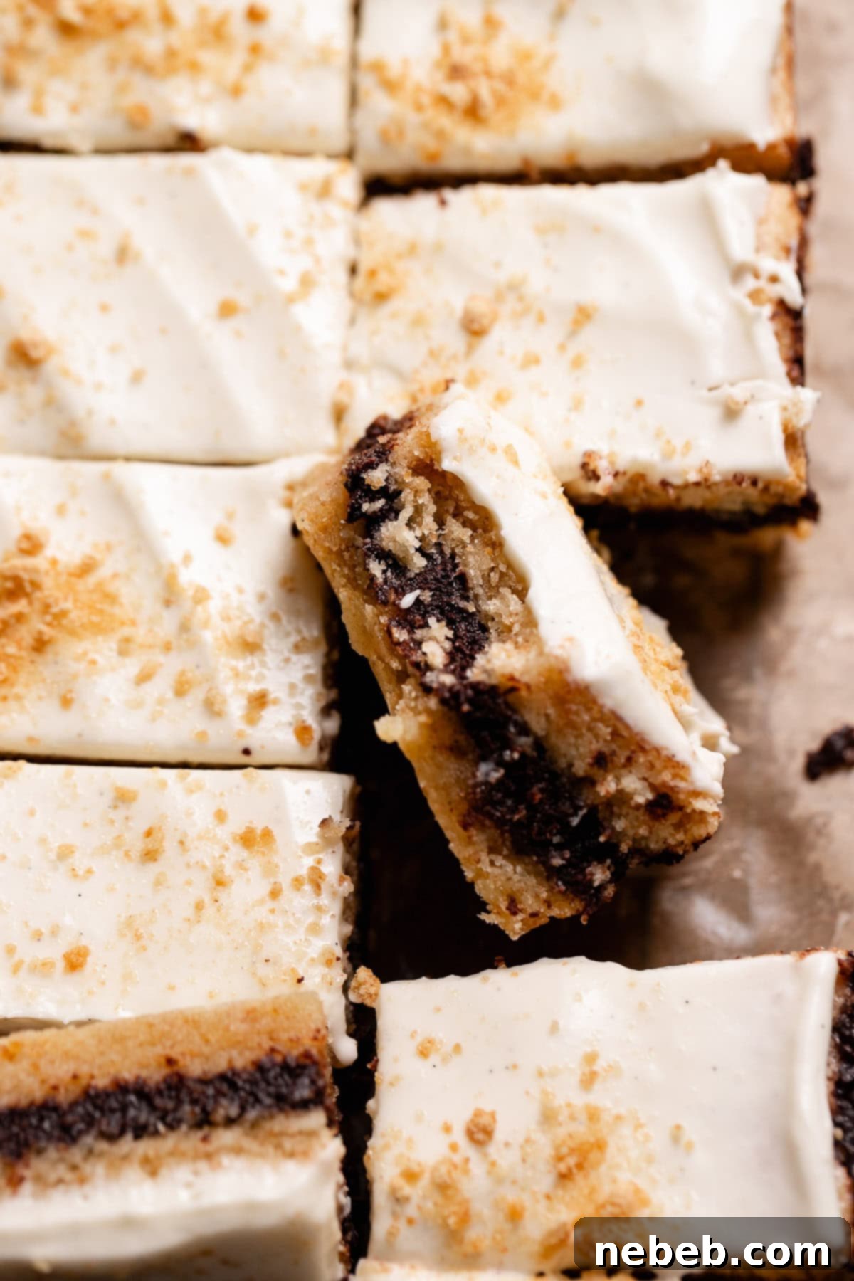 A single smores square leaning on the others missing a bite.