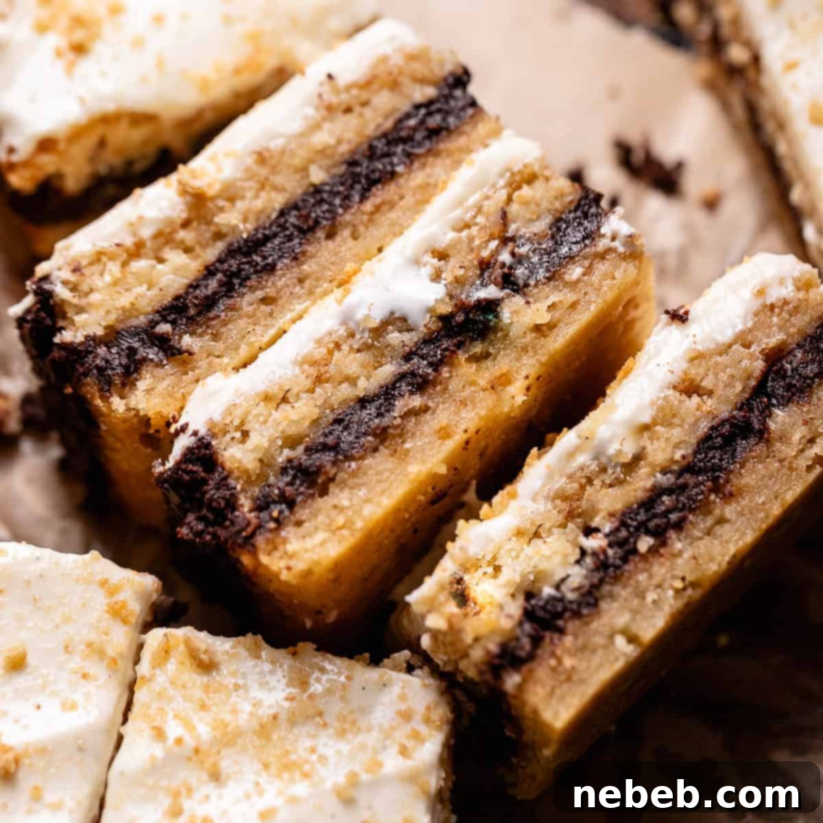 Graham cracker cookie bars with marshmallow frosting and chocolate filling.