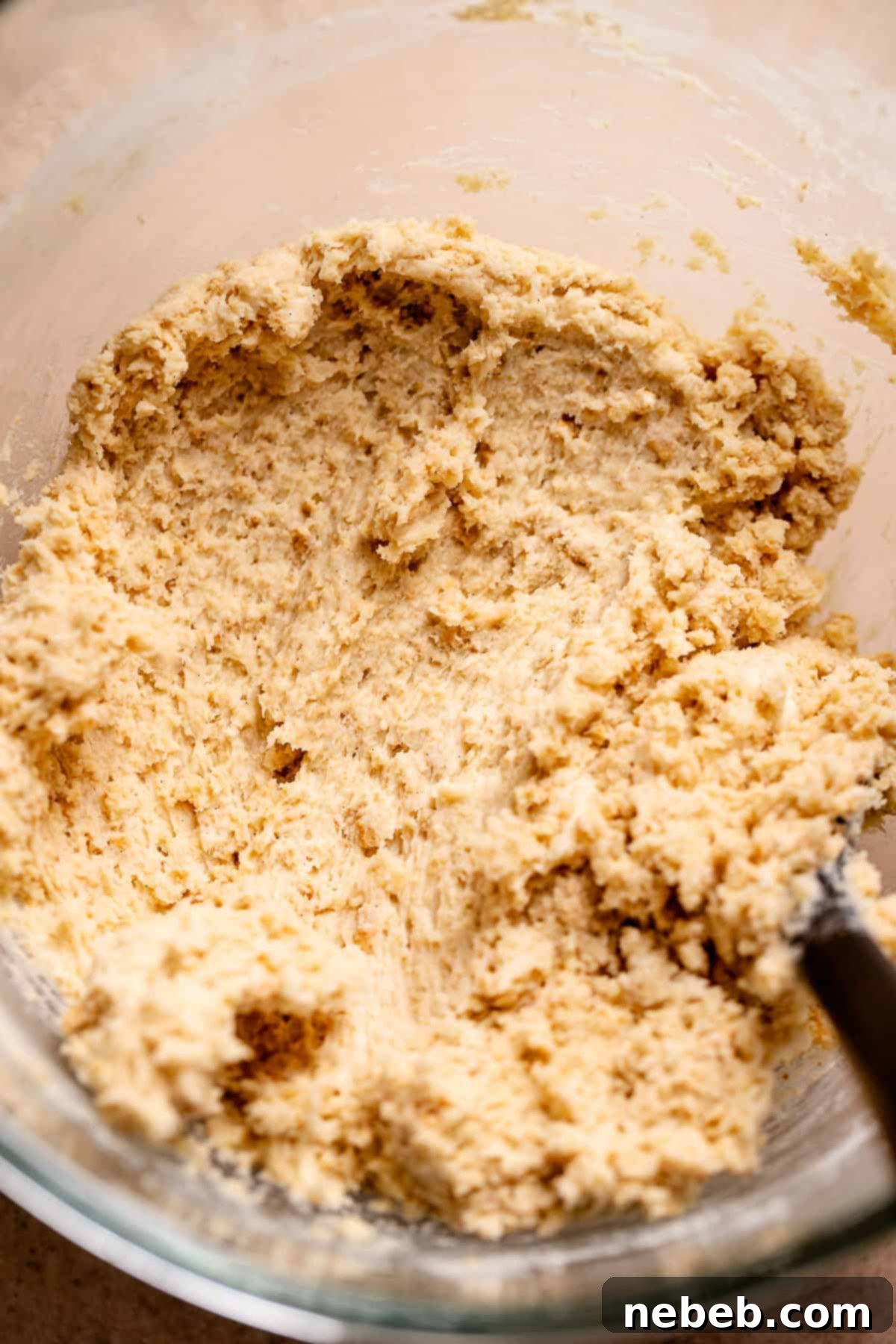 Graham cracker cookie dough in a glass stand mixer bowl.