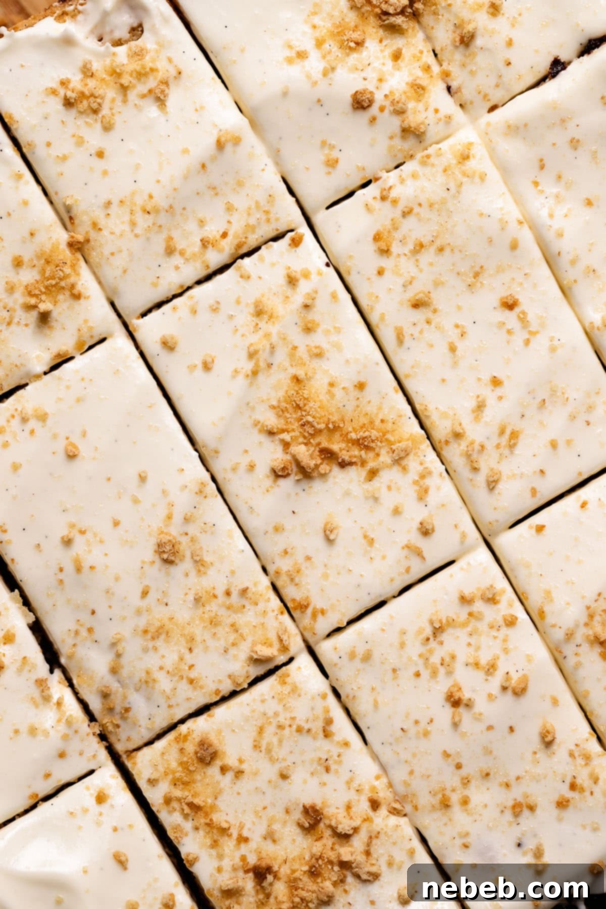 Smores cookie bars with marshmallow frosting cut into squares and sprinkled with graham cracker crumbs.
