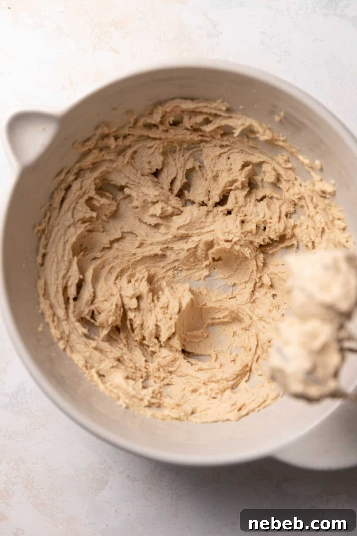 Creamed butter, granulated sugar, and brown sugar in a stand mixer bowl, light and fluffy.