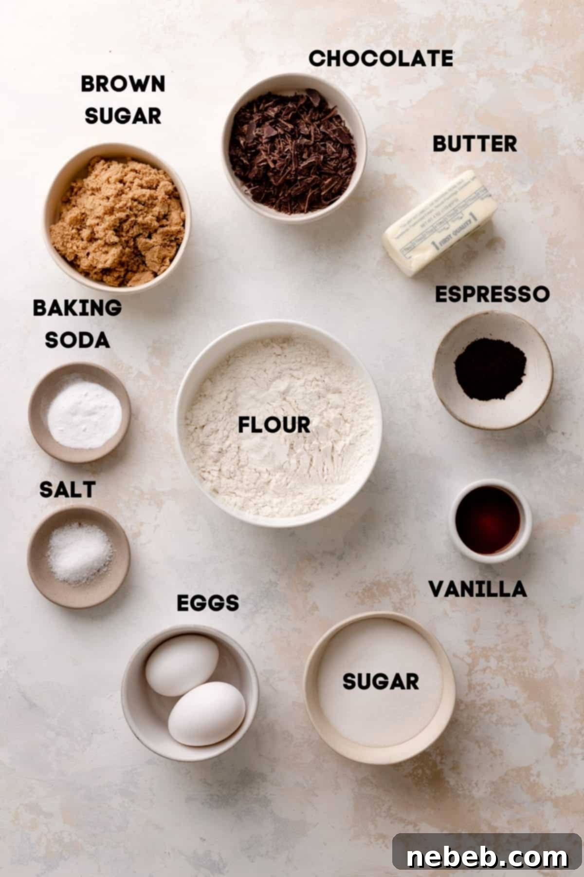 Coffee Kissed Chocolate Chip Cookies 3 A flat lay image showing all the essential ingredients laid out for making espresso chocolate chip cookies, including butter, espresso powder, sugars, flour, eggs, and chocolate chips.