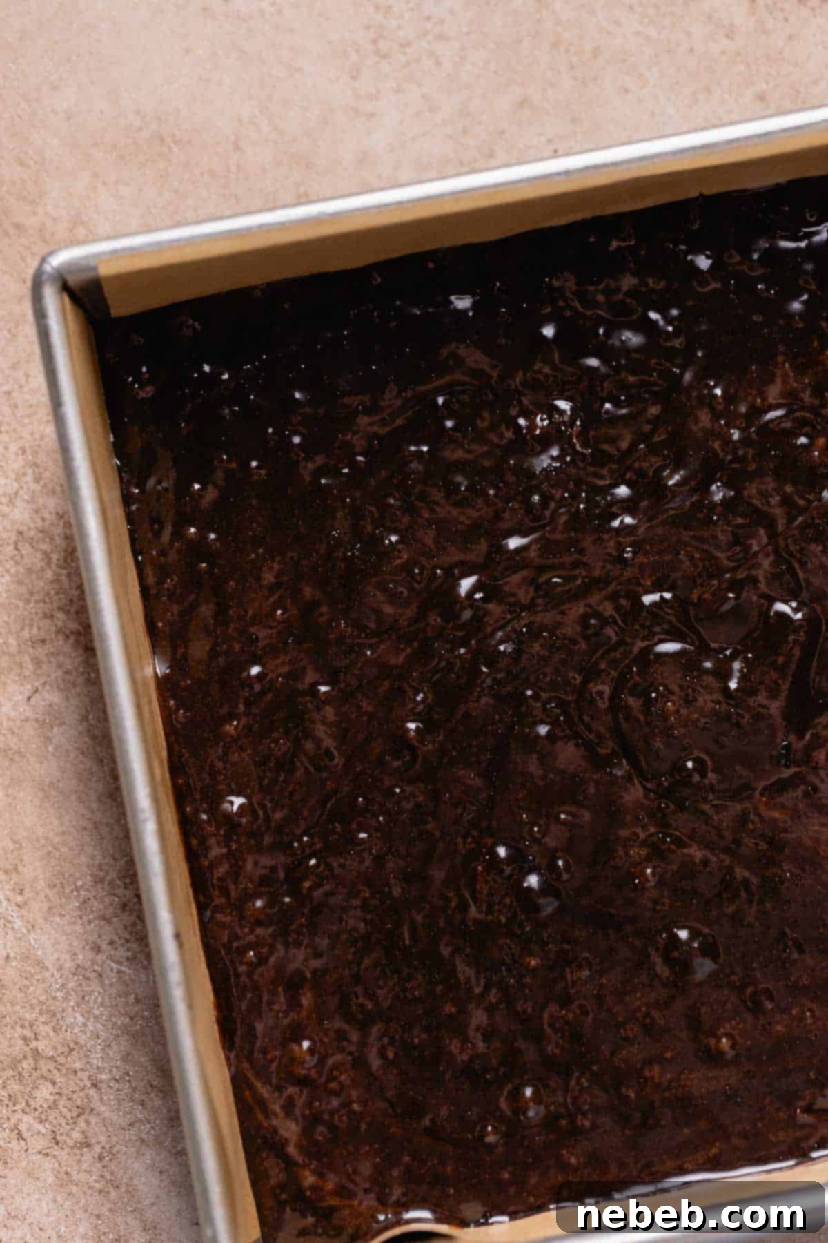 A baking pan full of the brownie batter before baking.