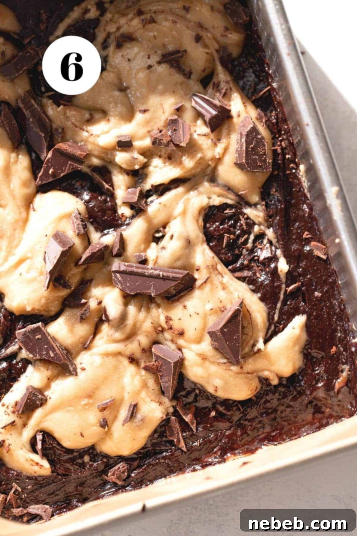 Brownie Blondie Bliss 6 A mouth-watering process shot of the beautifully swirled brownie and blondie batters in a baking pan, exhibiting a perfect marbled pattern just before it enters the oven.
