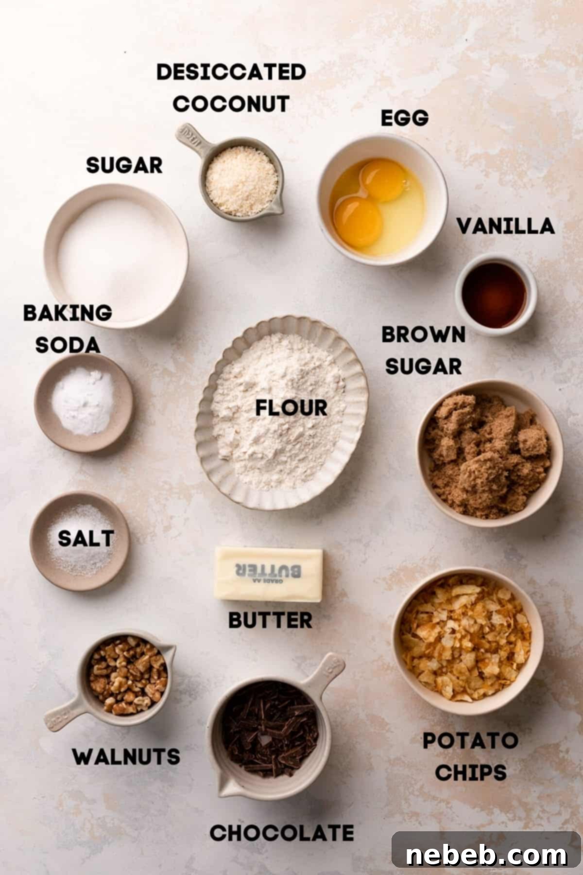 Million dollar cookie ingredients neatly arranged in bowls with labels, showing walnuts, chips, coconut, and chocolate.