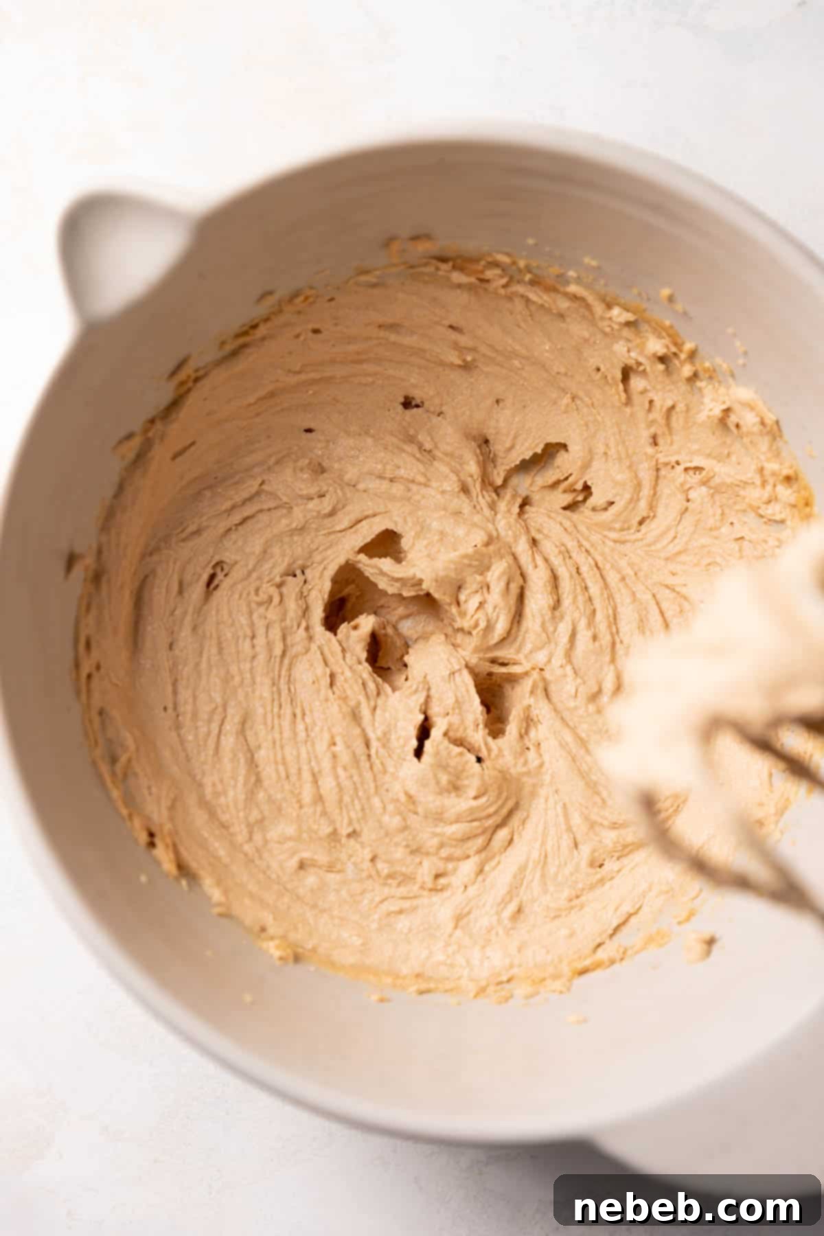 A mixing bowl with the creamed butter and sugar.