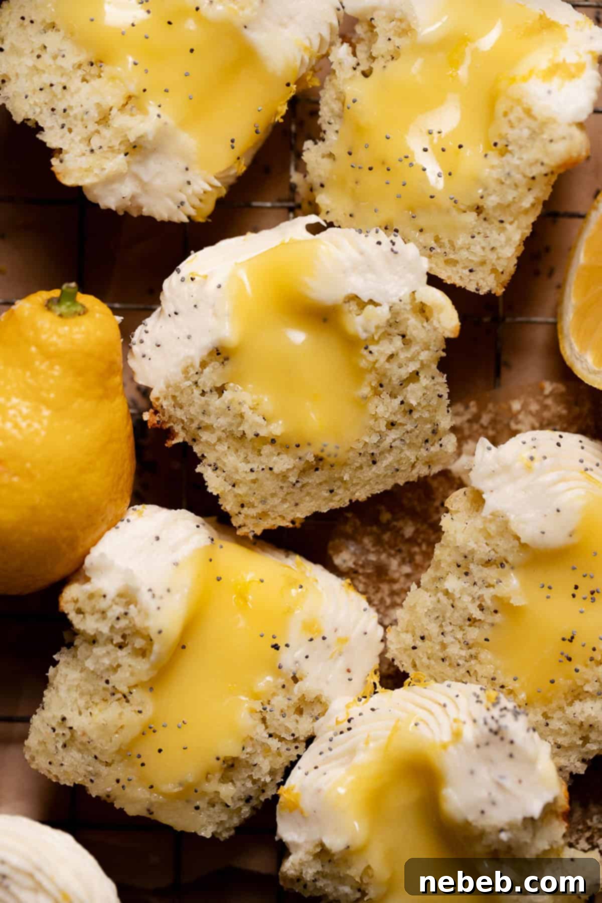 Lemon poppy seed cupcakes with a creamy lemon curd filling and a generous swirl of cream cheese frosting, garnished with fresh lemon zest and poppy seeds.