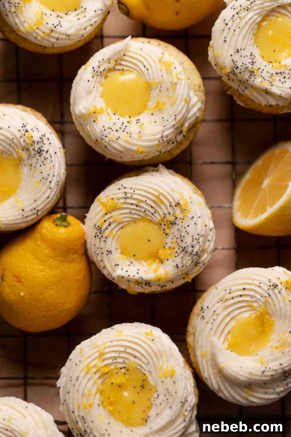 An overhead shot showcasing beautifully frosted lemon cupcakes with a distinct lemon curd filling visible in the center of the frosting.