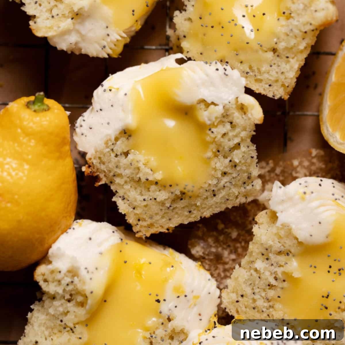 Lemon poppy seed cupcakes sliced in half, revealing the luscious lemon curd filling at their core.