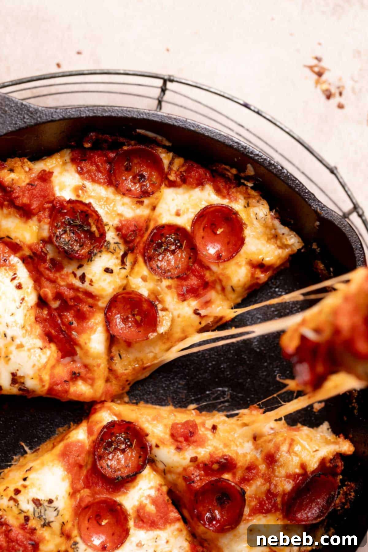 a slice of pizza being pulled from the cast iron skillet.