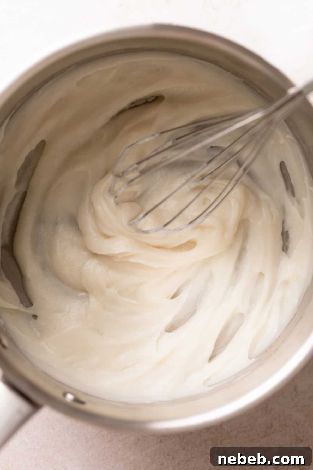 Tangzhong mixture in a pot being whisked to create a smooth, paste-like consistency.