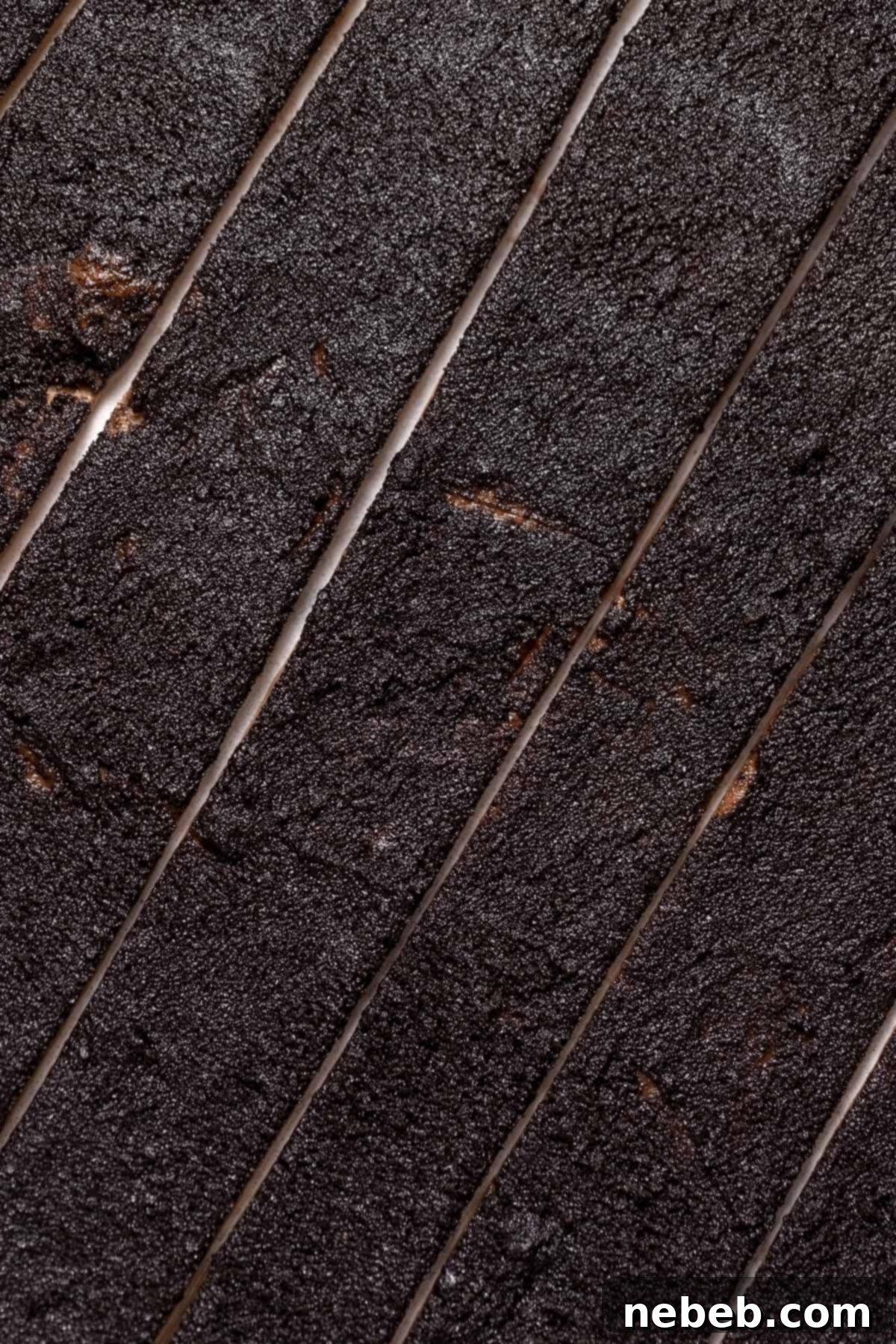 Strips of dough with chocolate Oreo filling generously spread on top, ready to be rolled.